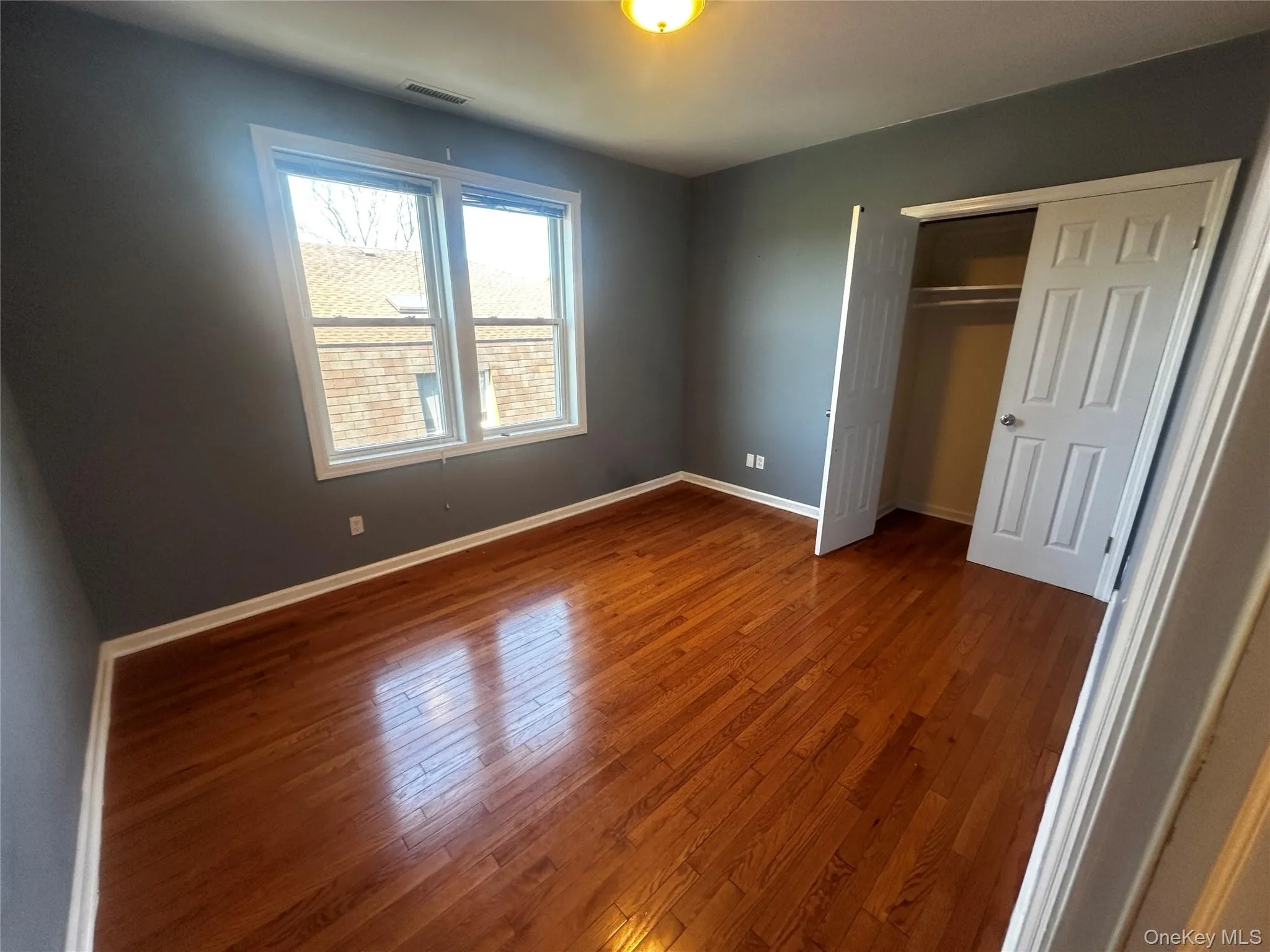 Bedroom 2 Features Large Closet space and Hardwood flooring complementing neutral wall tones Bedroom 2 Features Large Closet space and Hardwood flooring complementing neutral wall tones