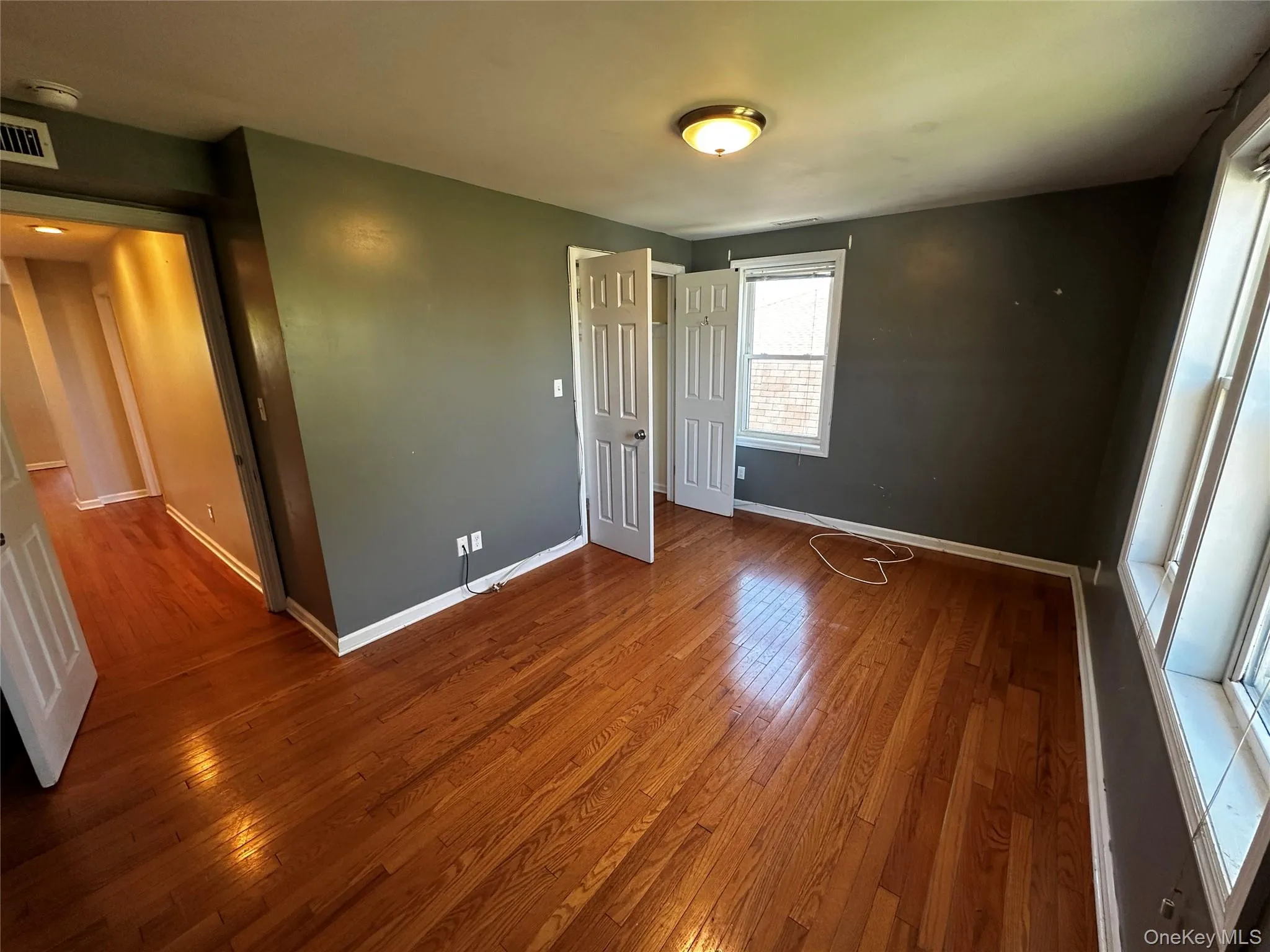 Bedroom 3 is the largest Bedroom featuring wood-finish flooring and many windows providing natural light Bedroom 3 is the largest Bedroom featuring wood-finish flooring and many windows providing natural light