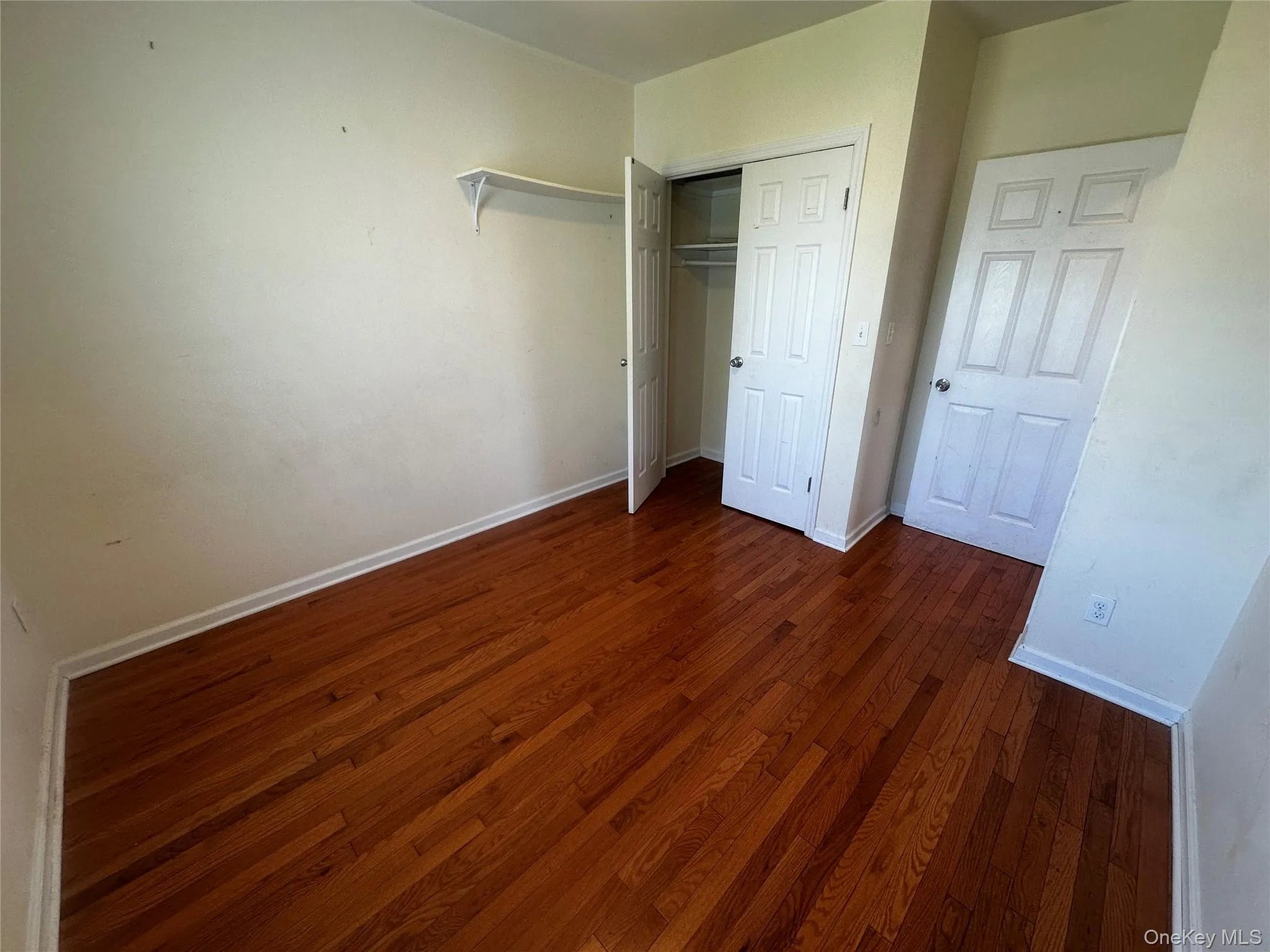 Bedroom 1 Features Rich wood-finish flooring complements light-toned walls Bedroom 1 Features Rich wood-finish flooring complements light-toned walls