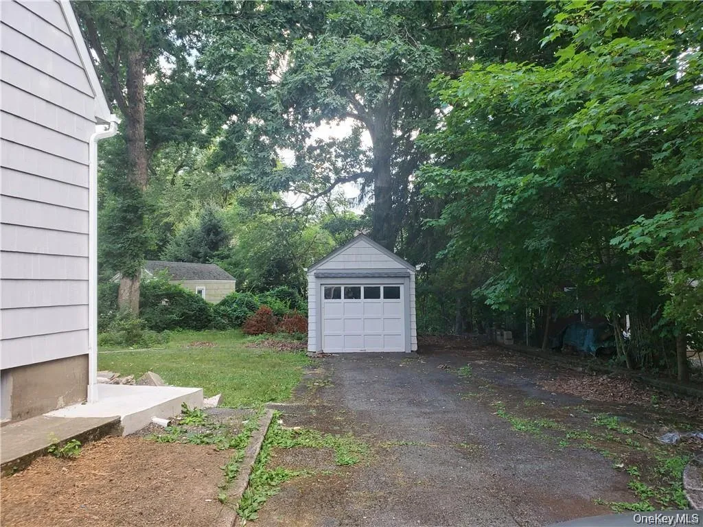 View of yard with a garage View of yard with a garage