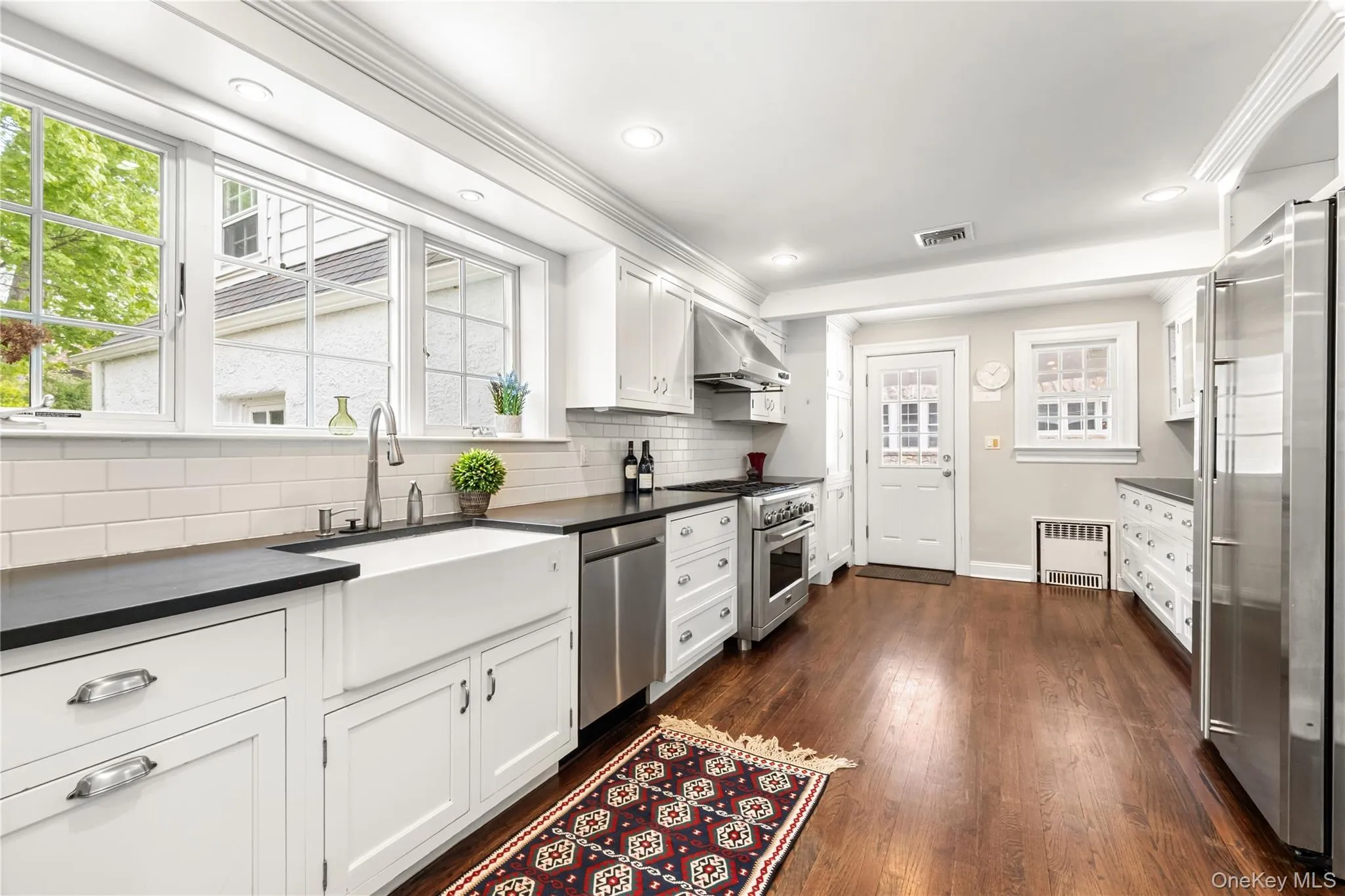 Updated kitchen with professional stainless steel appliances showing door to side covered porch Updated kitchen with professional stainless steel appliances showing door to side covered porch
