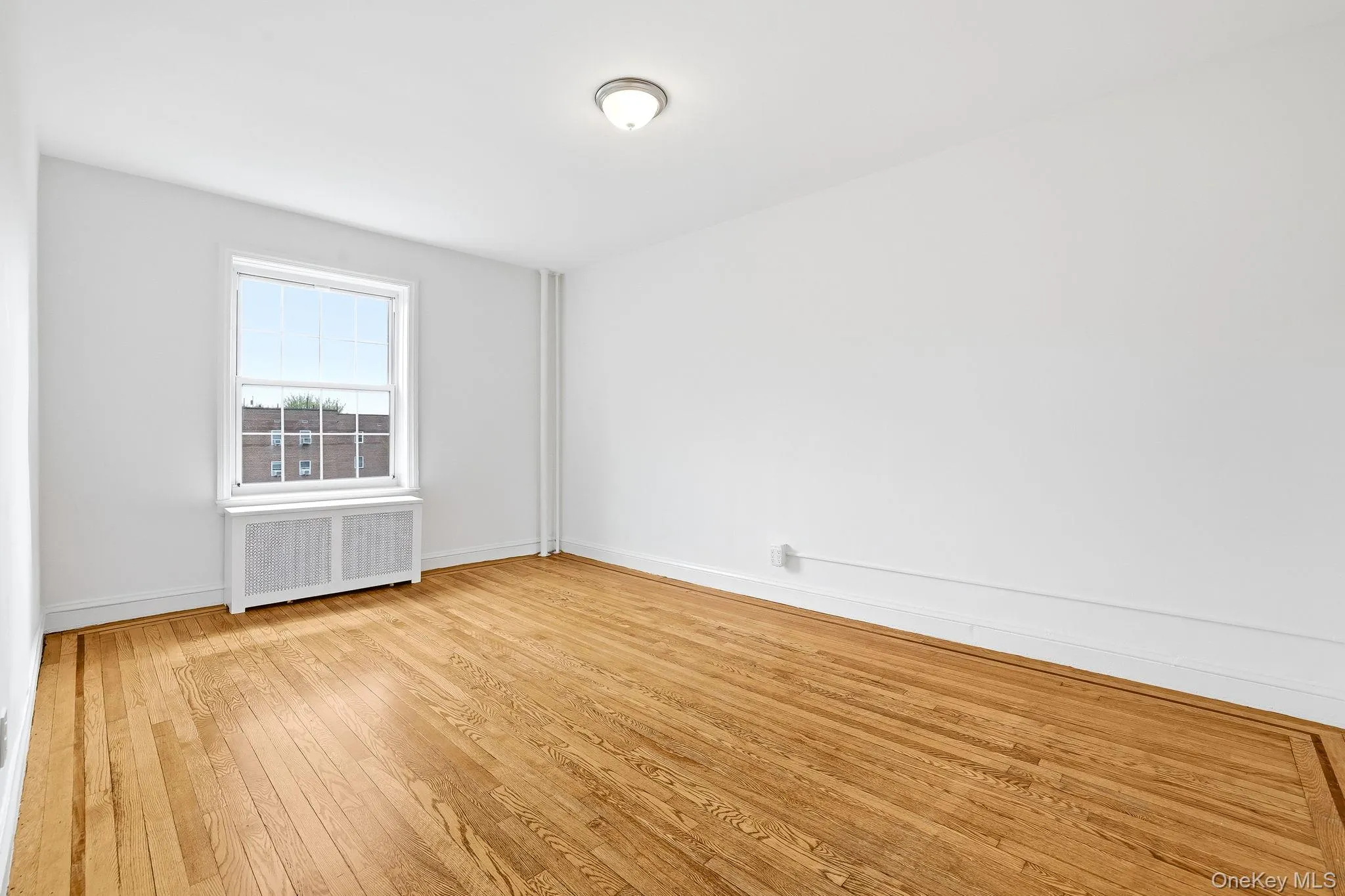 The second bedroom is equally spacious and also faces south, overlooking the front courtyard The second bedroom is equally spacious and also faces south, overlooking the front courtyard