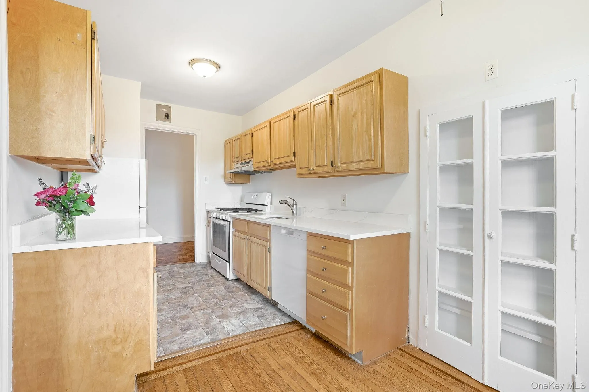 The breakfast area in the kitchen showcases a delightful built-in French door wall cabinet, for display or for use as a pantry The breakfast area in the kitchen showcases a delightful built-in French door wall cabinet, for display or for use as a pantry