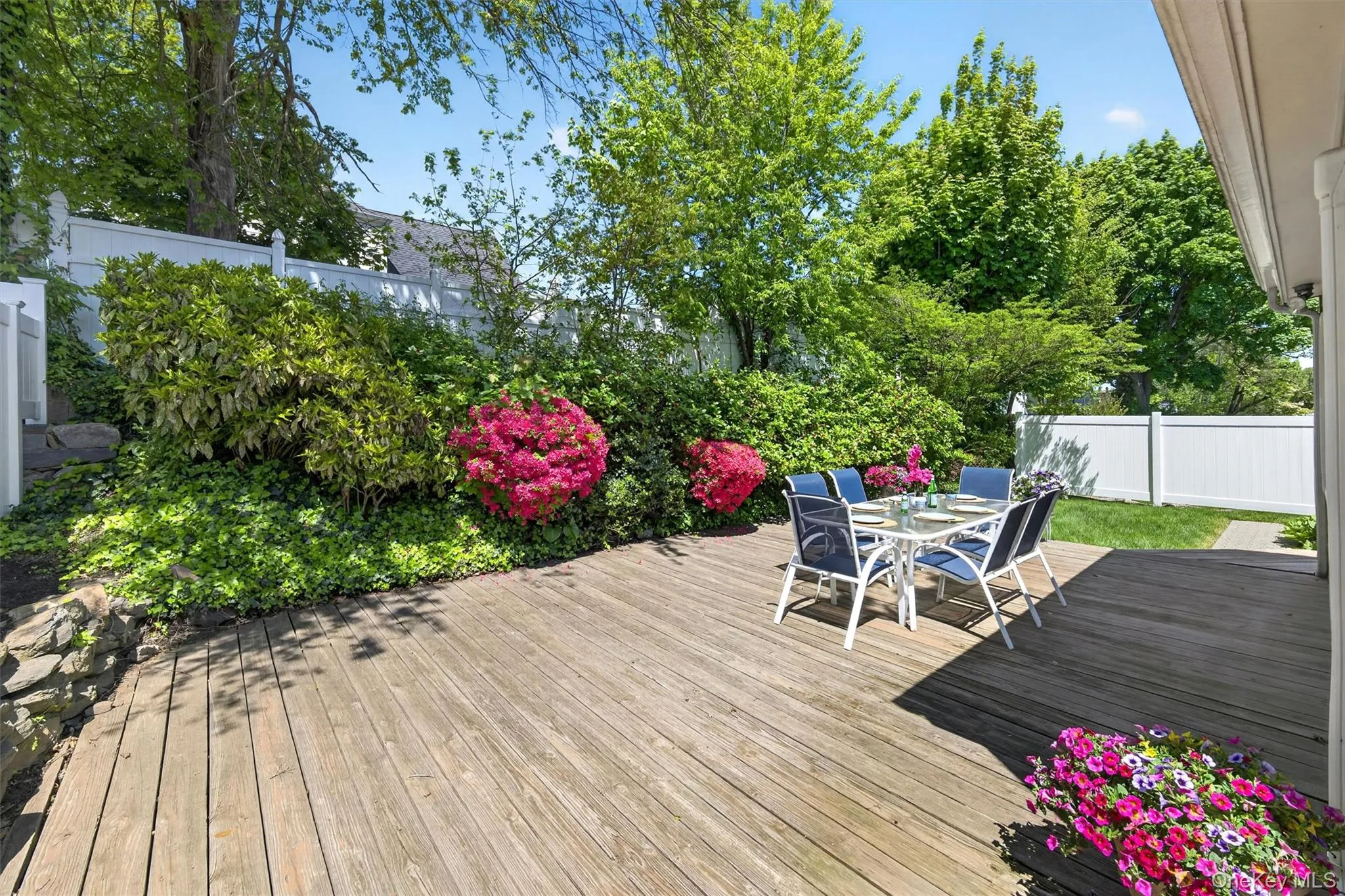 Spacious deck with beautiful landscaping perfect for relaxing or dining with friends Spacious deck with beautiful landscaping perfect for relaxing or dining with friends