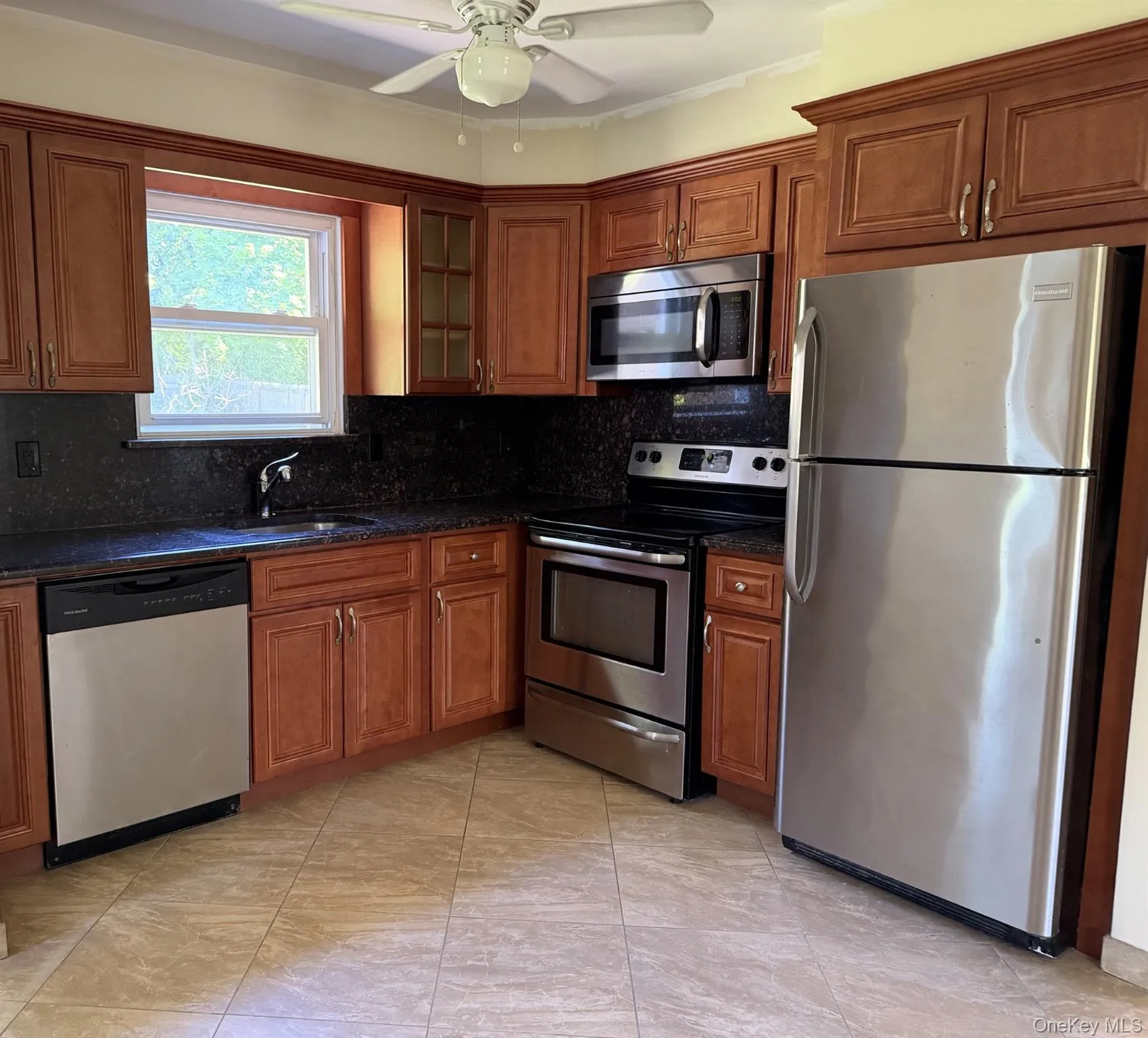 Stainless steel appliance, tile floor, rear door to the yard with patio. Stainless steel appliance, tile floor, rear door to the yard with patio.