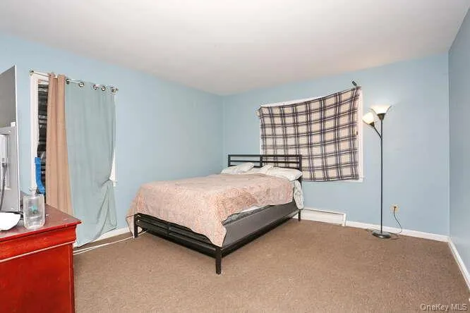Bedroom featuring carpet floors and baseboards Bedroom featuring carpet floors and baseboards