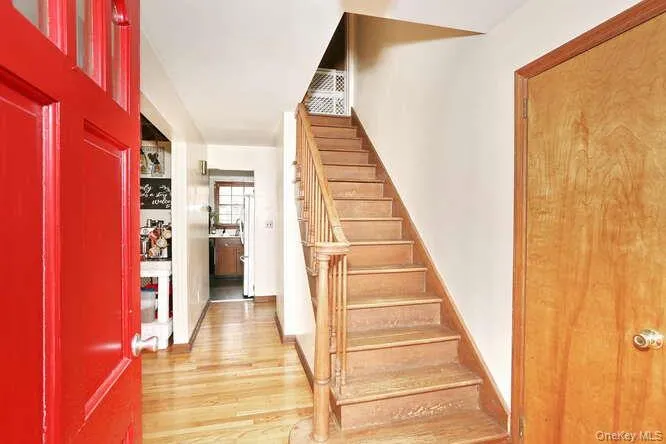 Entryway featuring light wood-style floors and stairs Entryway featuring light wood-style floors and stairs