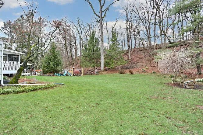 View of yard featuring a sunroom View of yard featuring a sunroom