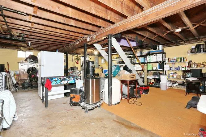 Unfinished basement featuring freestanding refrigerator Unfinished basement featuring freestanding refrigerator
