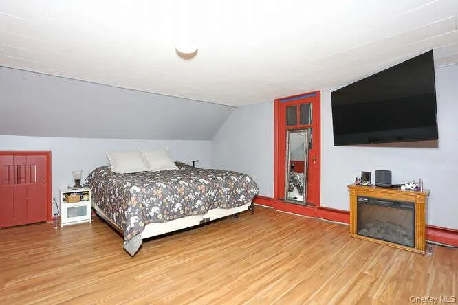 Bedroom with wood finished floors and lofted ceiling Bedroom with wood finished floors and lofted ceiling