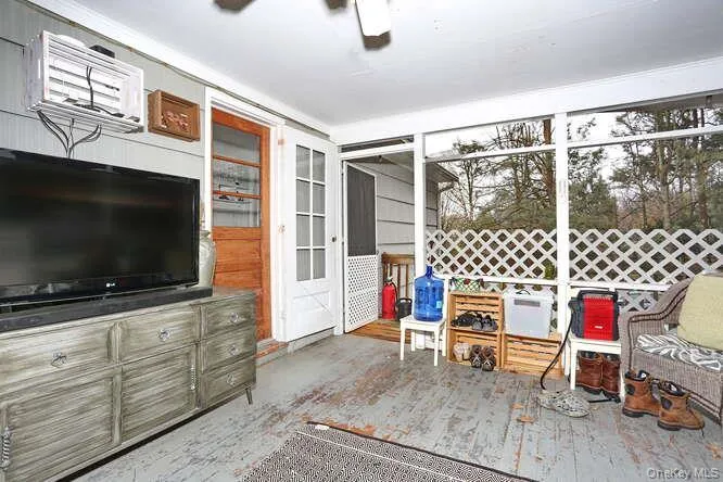 Sunroom featuring a ceiling fan Sunroom featuring a ceiling fan