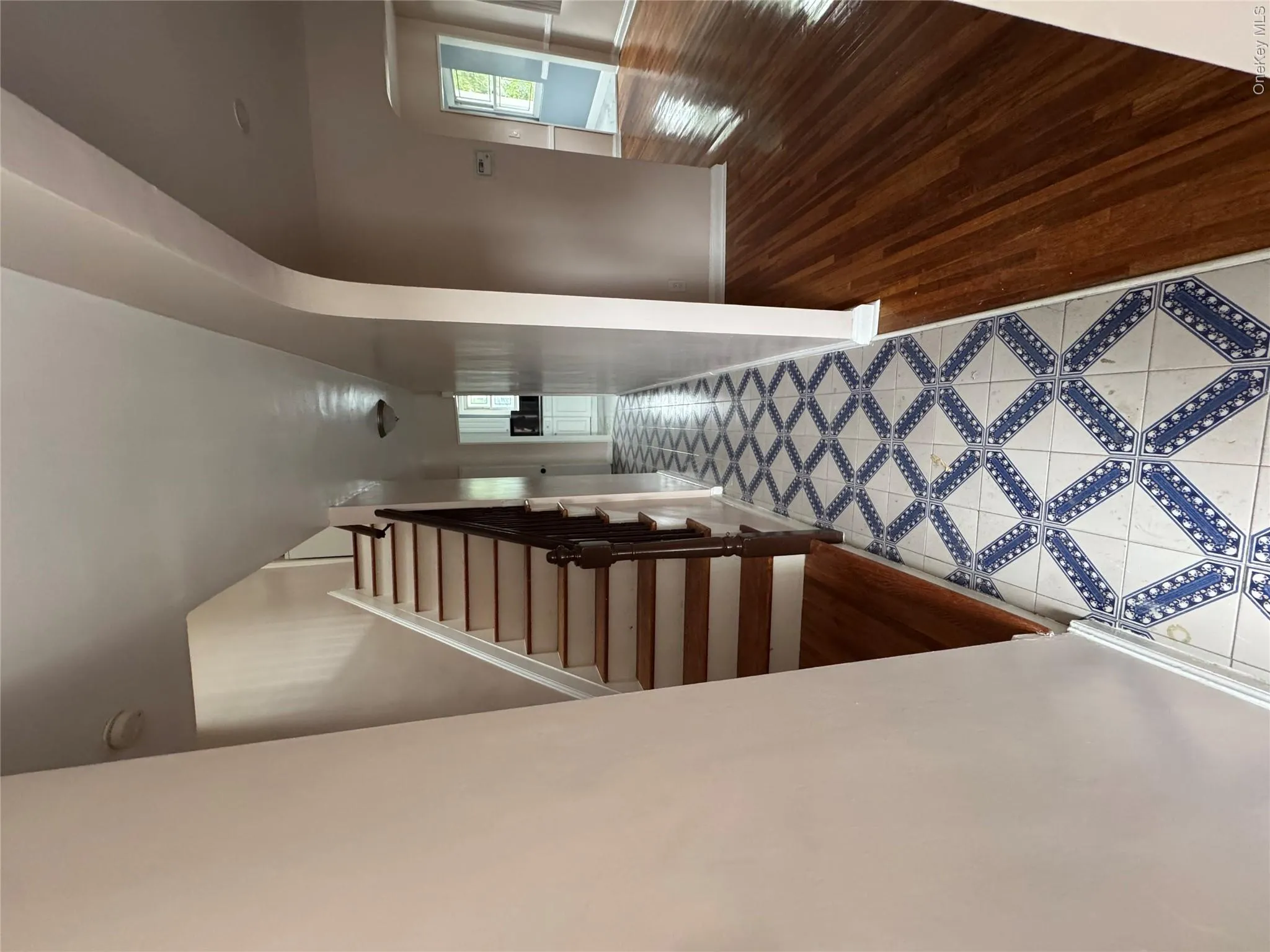 Staircase featuring arched walkways, tile patterned floors, inlaid floor details, and plenty of natural light Staircase featuring arched walkways, tile patterned floors, inlaid floor details, and plenty of natural light