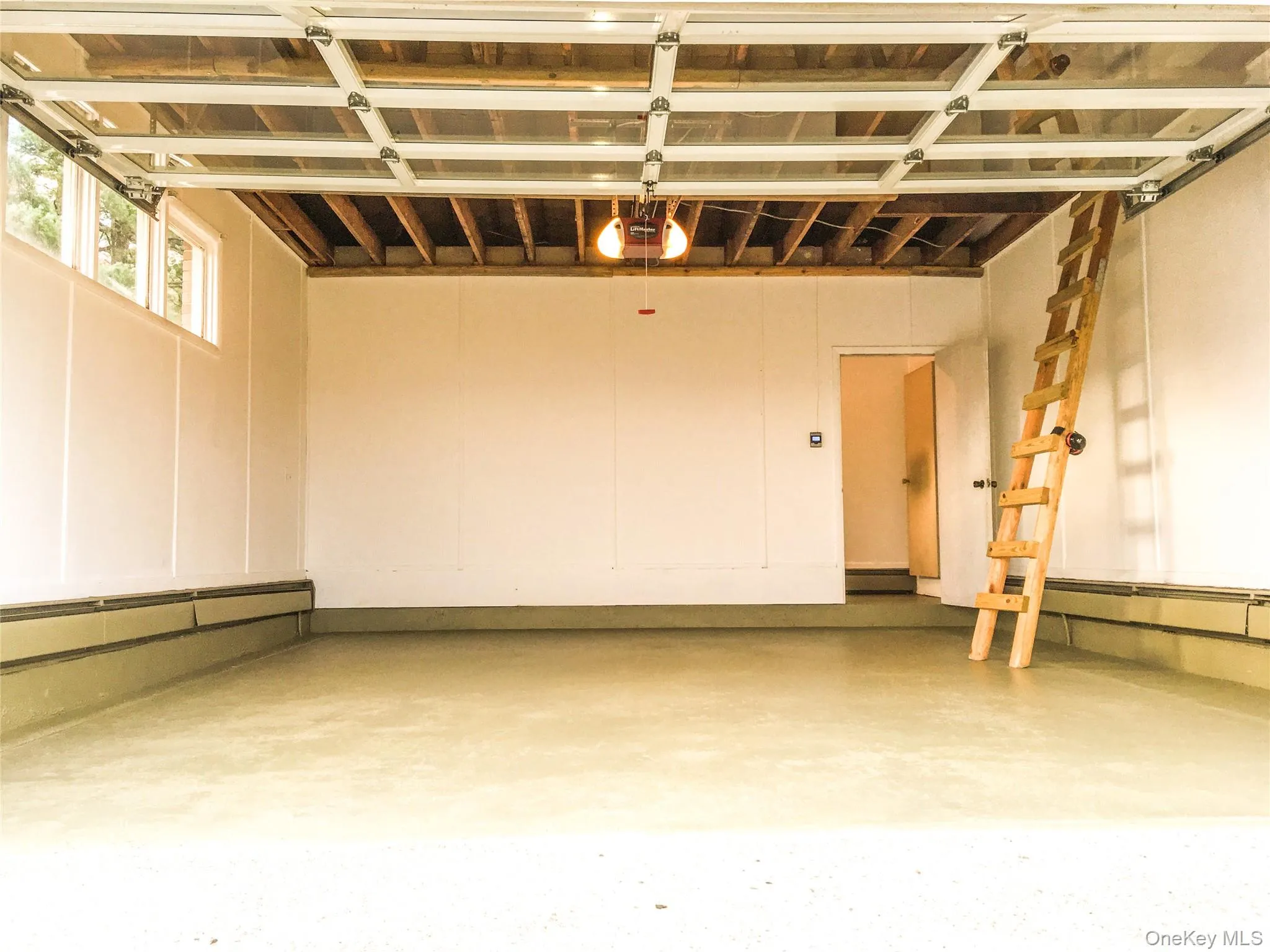 Garage with entrance to workshop Garage with entrance to workshop