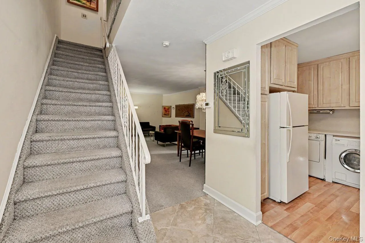 View of stairs up to bedrooms shows kitchen on right View of stairs up to bedrooms shows kitchen on right