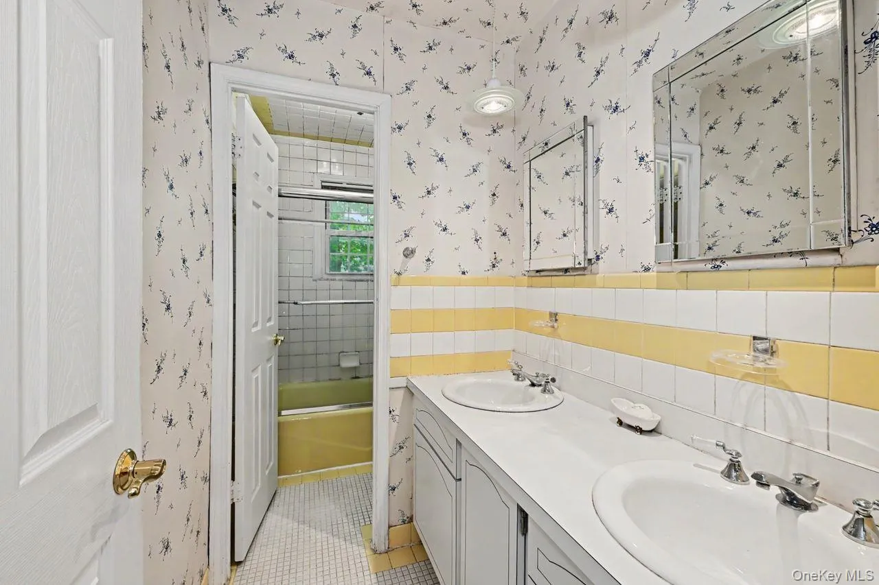 Bathroom with double sinks and separate room with toilet and tub Bathroom with double sinks and separate room with toilet and tub