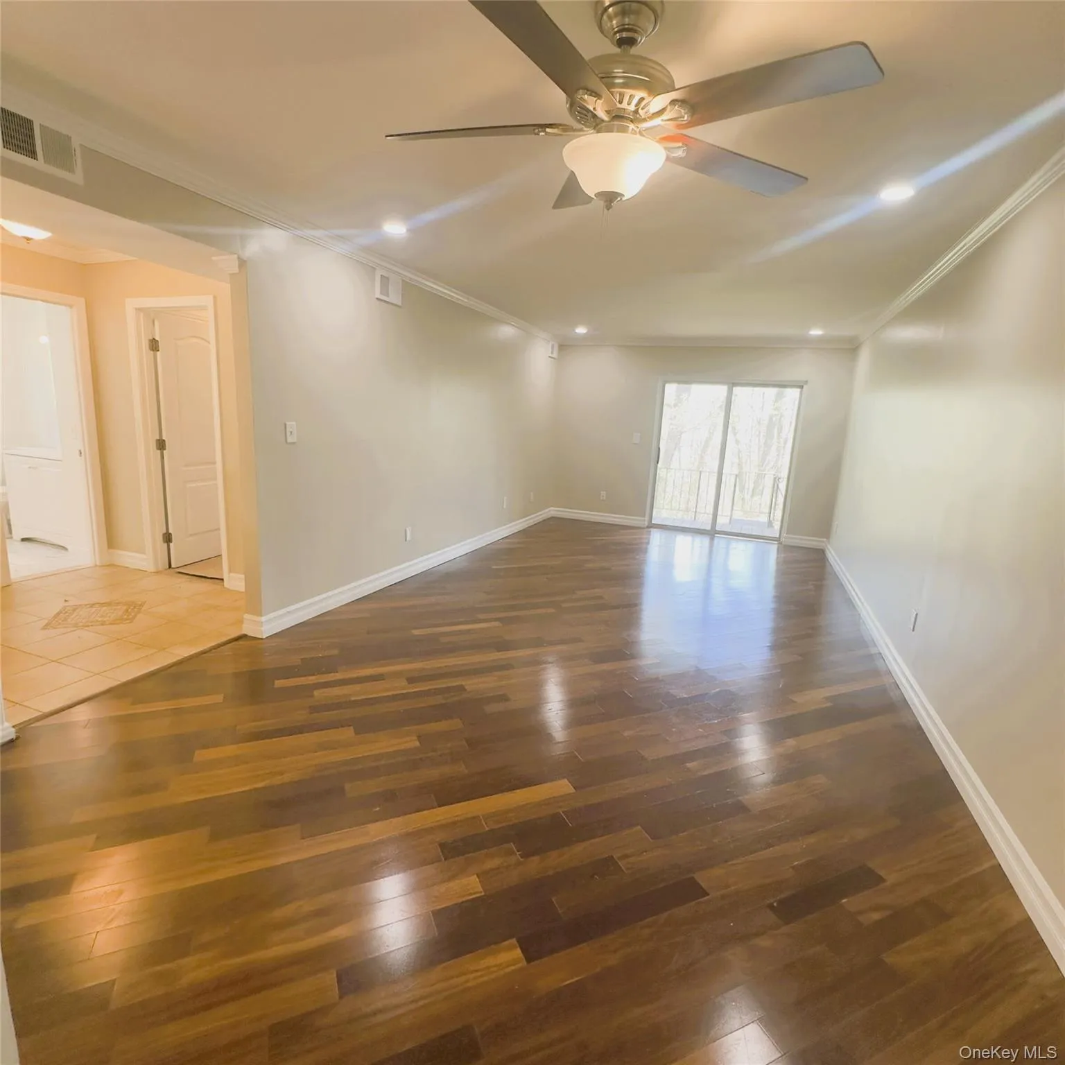 Wooden flooring, ceiling fan, recess lighting, crown molding Wooden flooring, ceiling fan, recess lighting, crown molding
