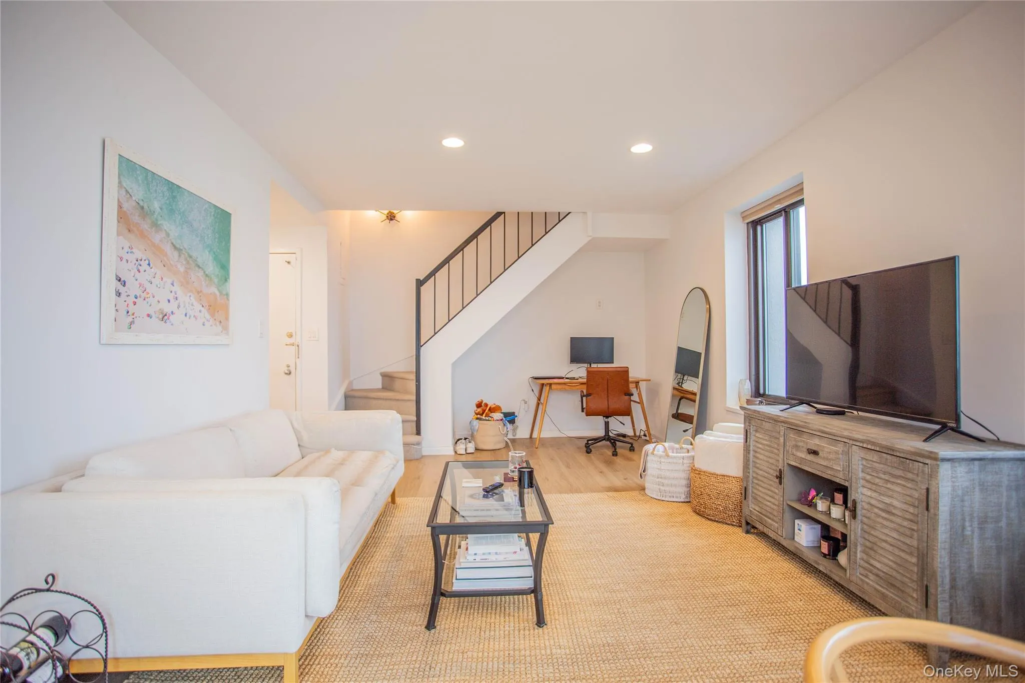 Living room with stairs, wood finished floors, and recessed lighting Living room with stairs, wood finished floors, and recessed lighting