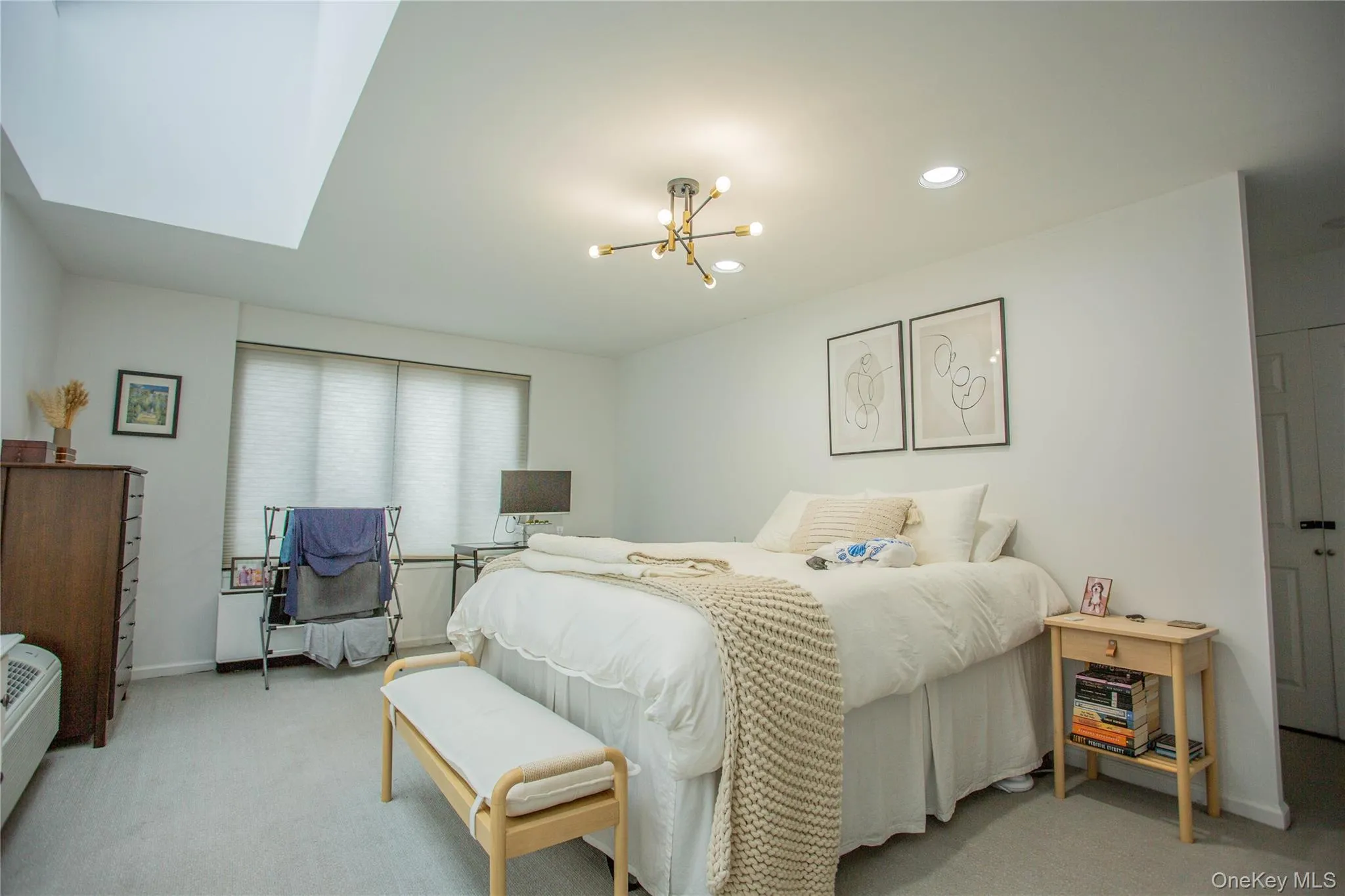 Bedroom with a notable chandelier, recessed lighting, baseboards, and carpet floors Bedroom with a notable chandelier, recessed lighting, baseboards, and carpet floors