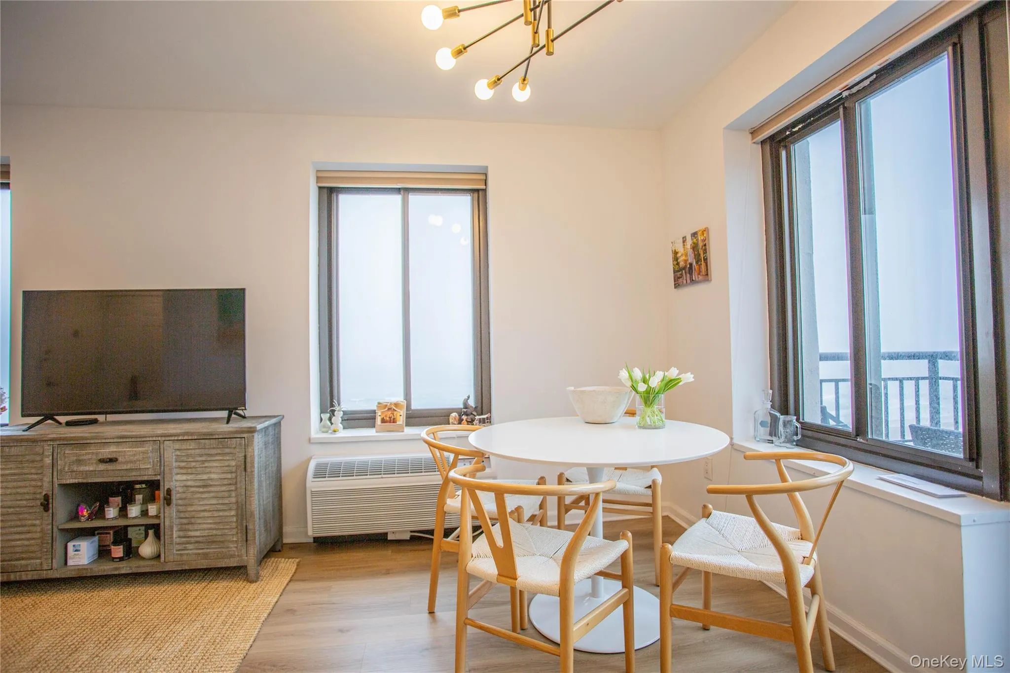 Dining space with a wealth of natural light, baseboards, and light wood-style floors Dining space with a wealth of natural light, baseboards, and light wood-style floors