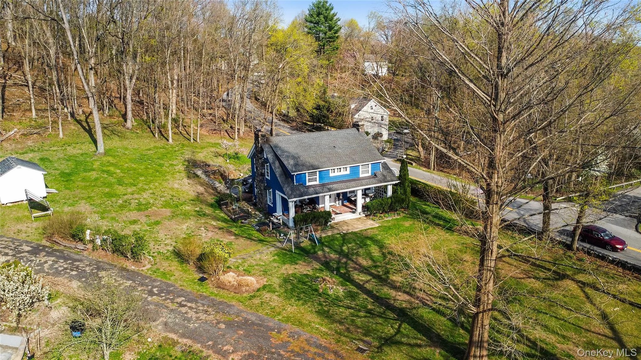 Blue exterior residence with a covered front porch and dormer window Blue exterior residence with a covered front porch and dormer window