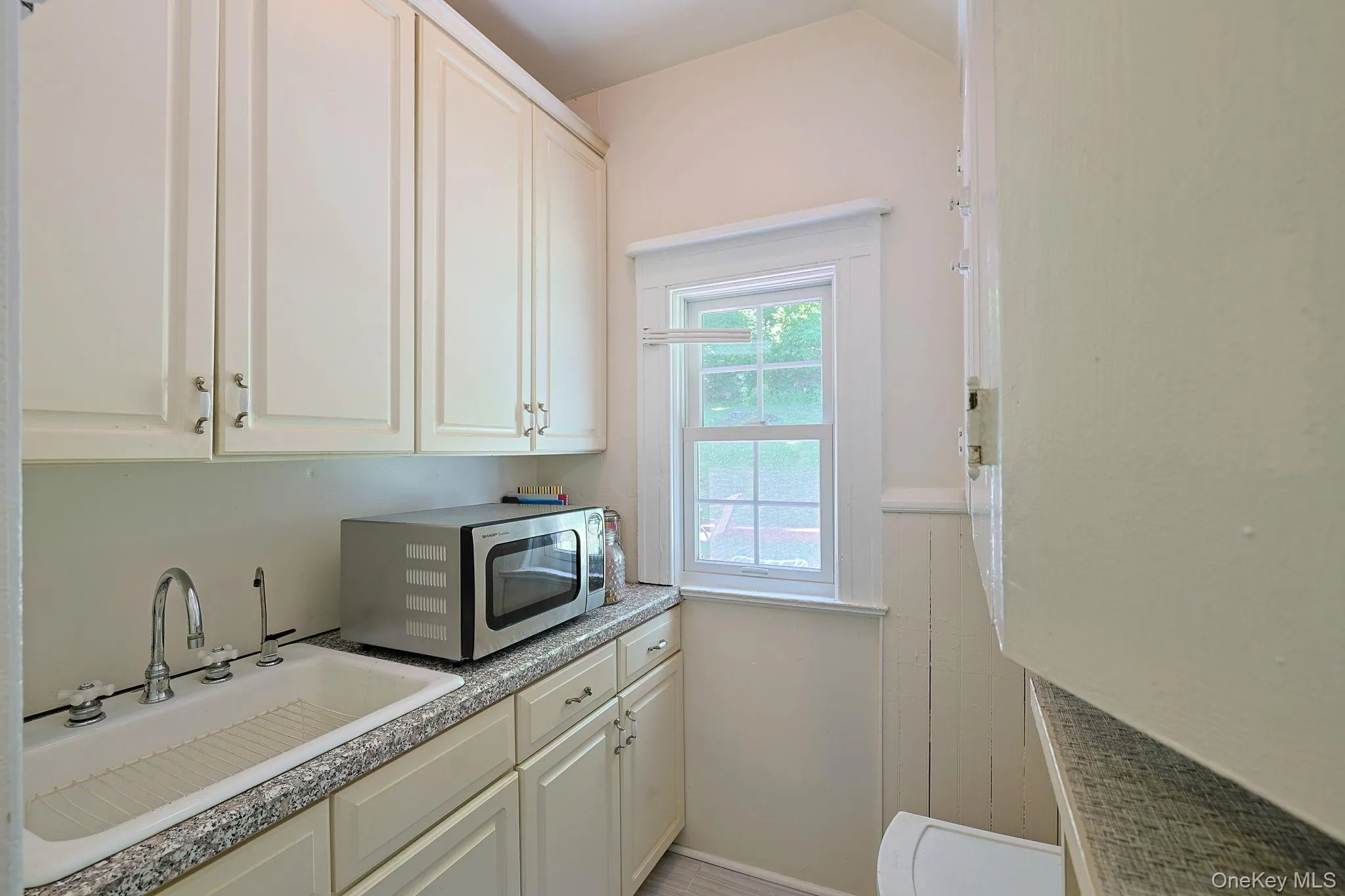 Spacious butler pantry with sink and storage cabinets. Spacious butler pantry with sink and storage cabinets.