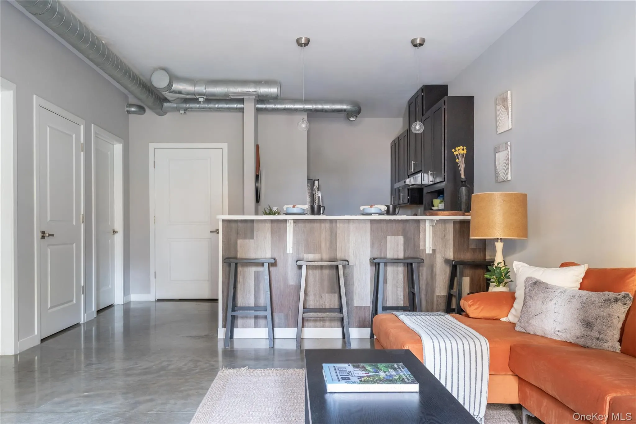Open concept living area with exposed ductwork Open concept living area with exposed ductwork