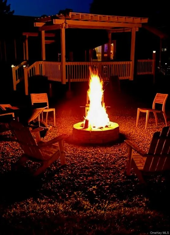 Night view of side of house with firepit area Night view of side of house with firepit area