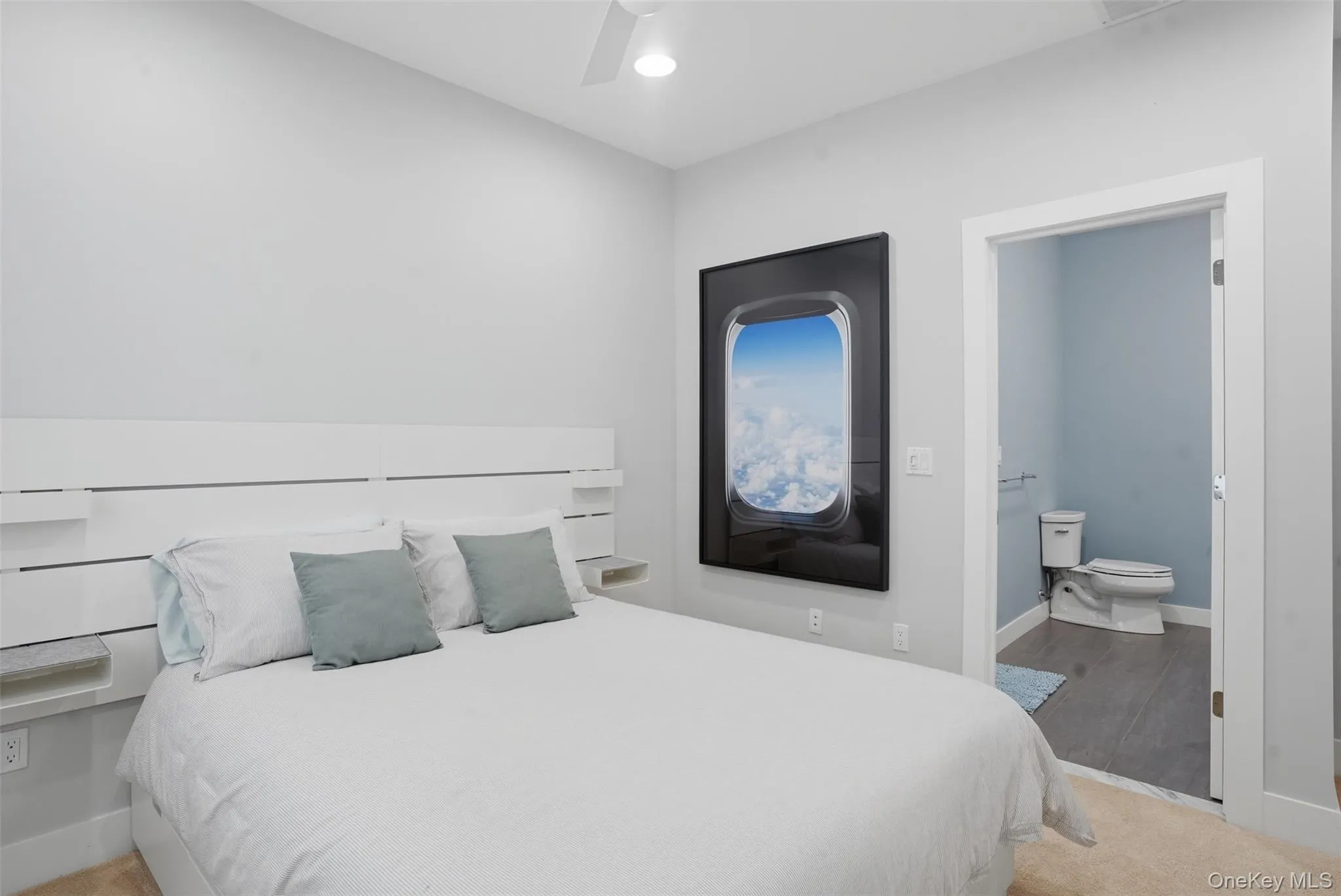 Bedroom with light gray walls, a white ceiling fan, and carpet flooring Bedroom with light gray walls, a white ceiling fan, and carpet flooring