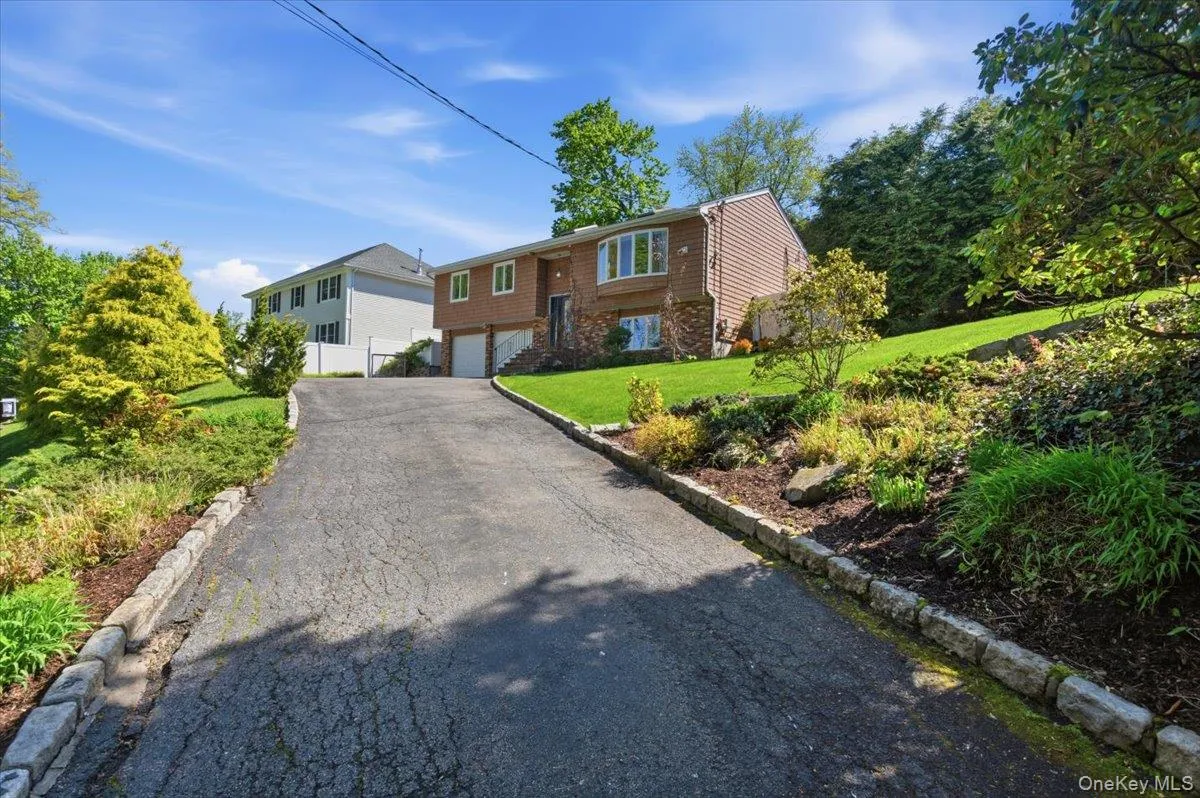 The large driveway and two car garage allows for ample parking. The large driveway and two car garage allows for ample parking.
