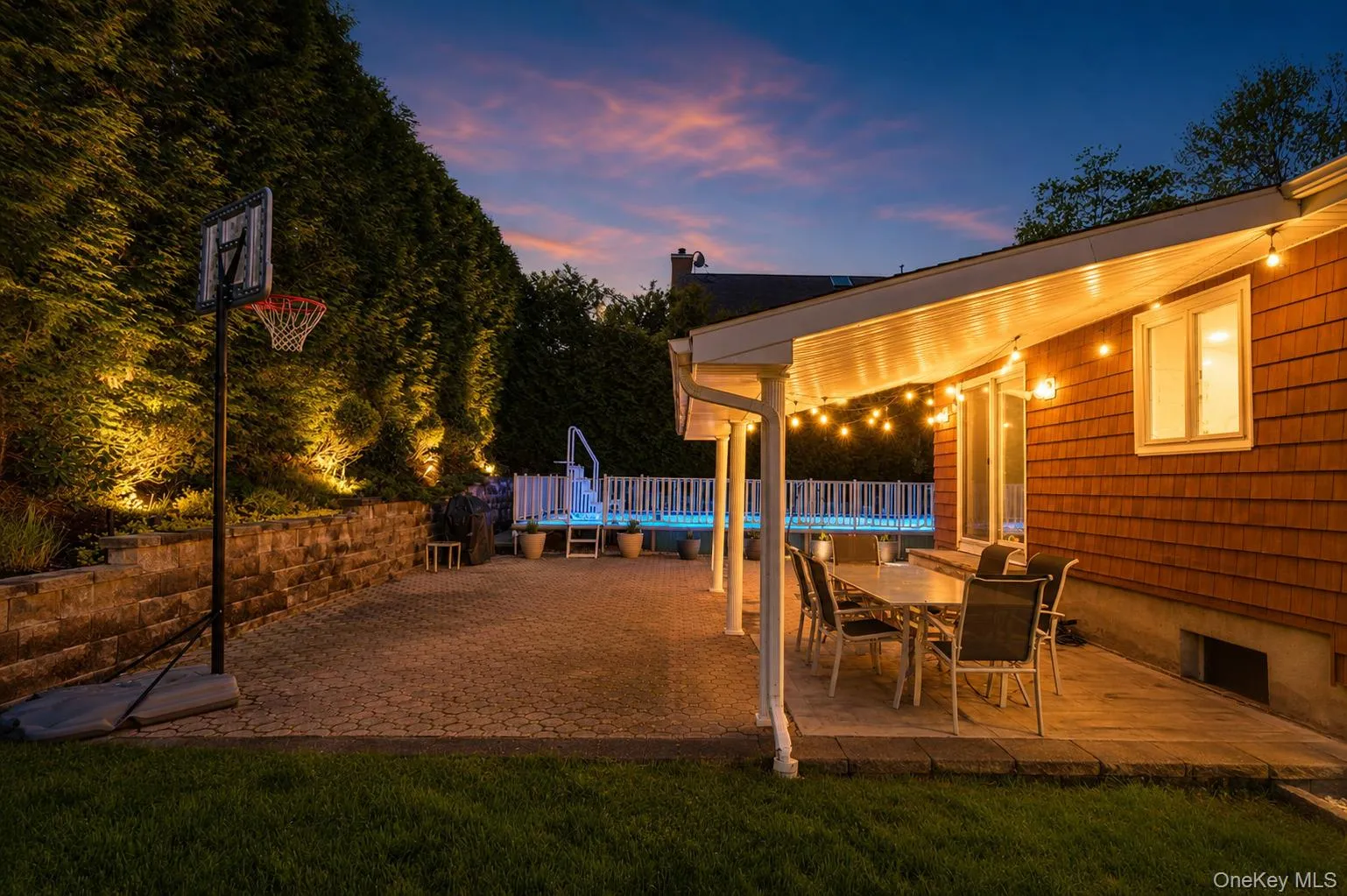 A twilight view of the rear yard. Enjoy summer nights with your very own pool! A twilight view of the rear yard. Enjoy summer nights with your very own pool!