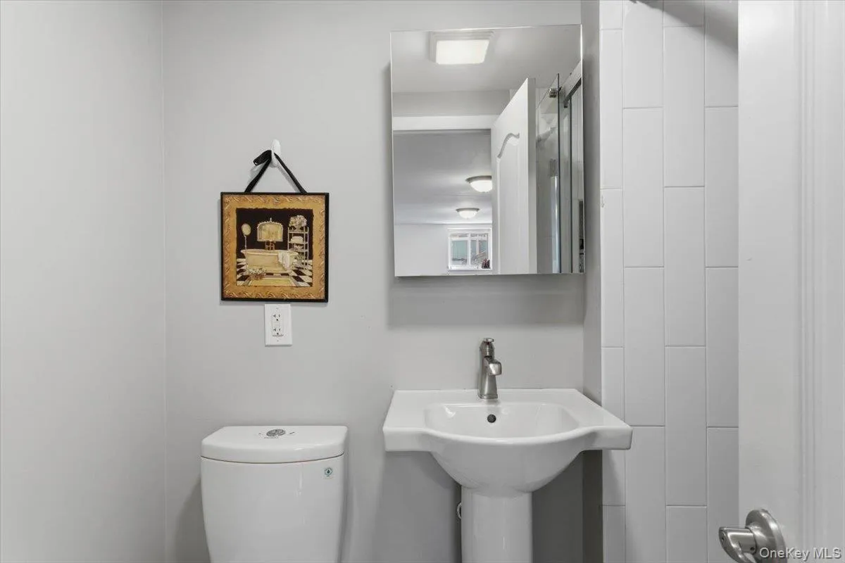 View of the full bathroom off of the rec room. View of the full bathroom off of the rec room.