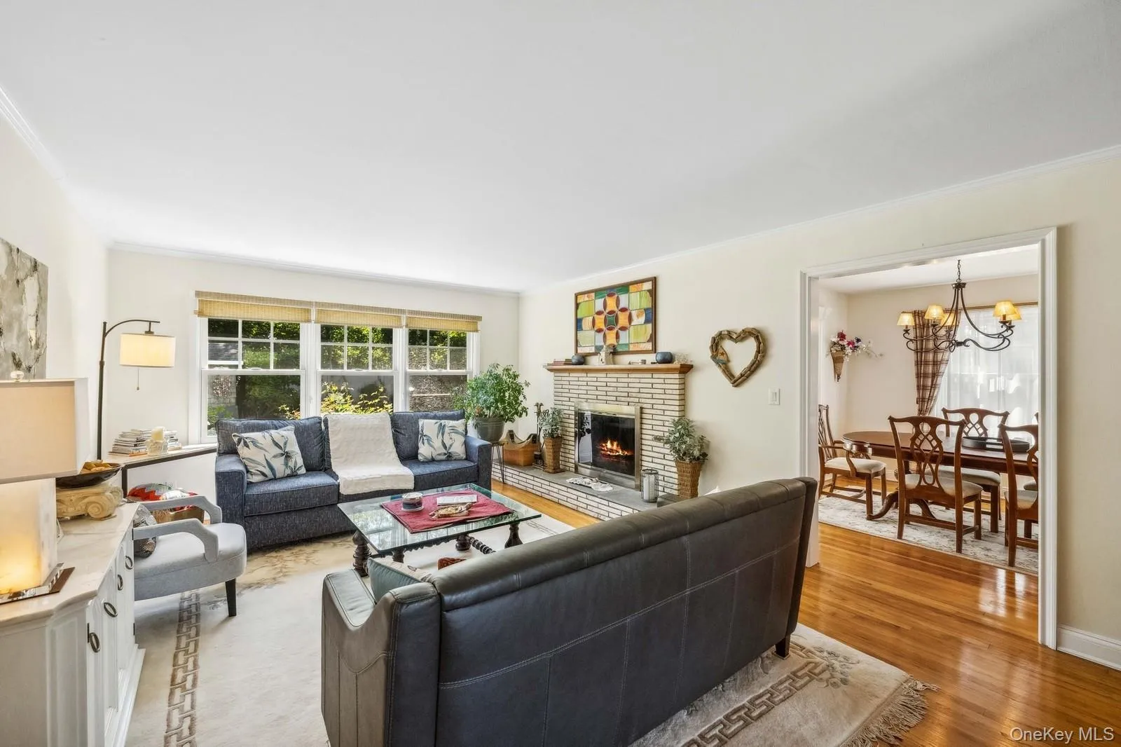 Living room with backyard view, hardwood floor and a fireplace Living room with backyard view, hardwood floor and a fireplace