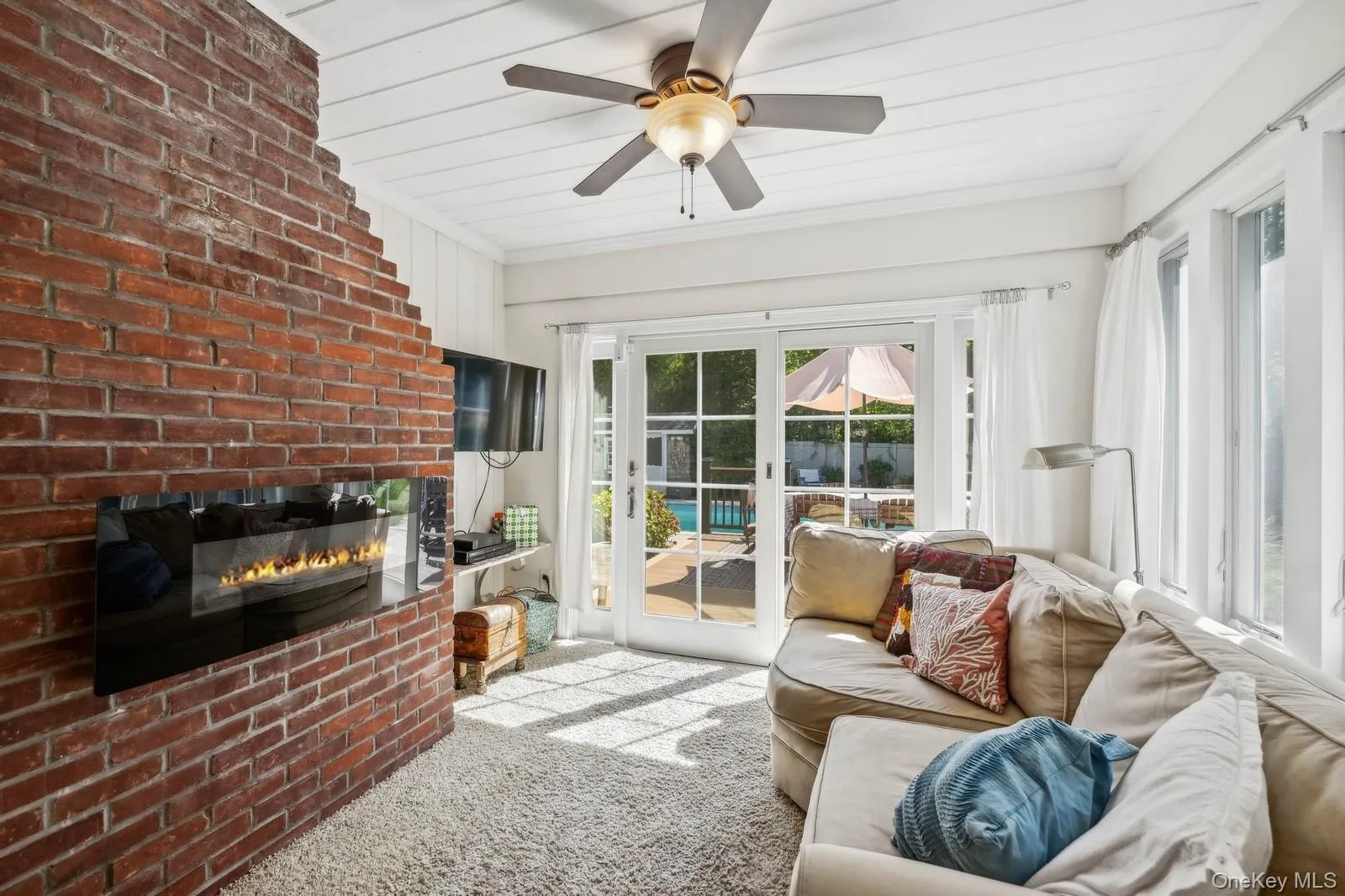 Bright Sunroom/Den with ceiling fan, TV, fireplace and sliders to deck Bright Sunroom/Den with ceiling fan, TV, fireplace and sliders to deck