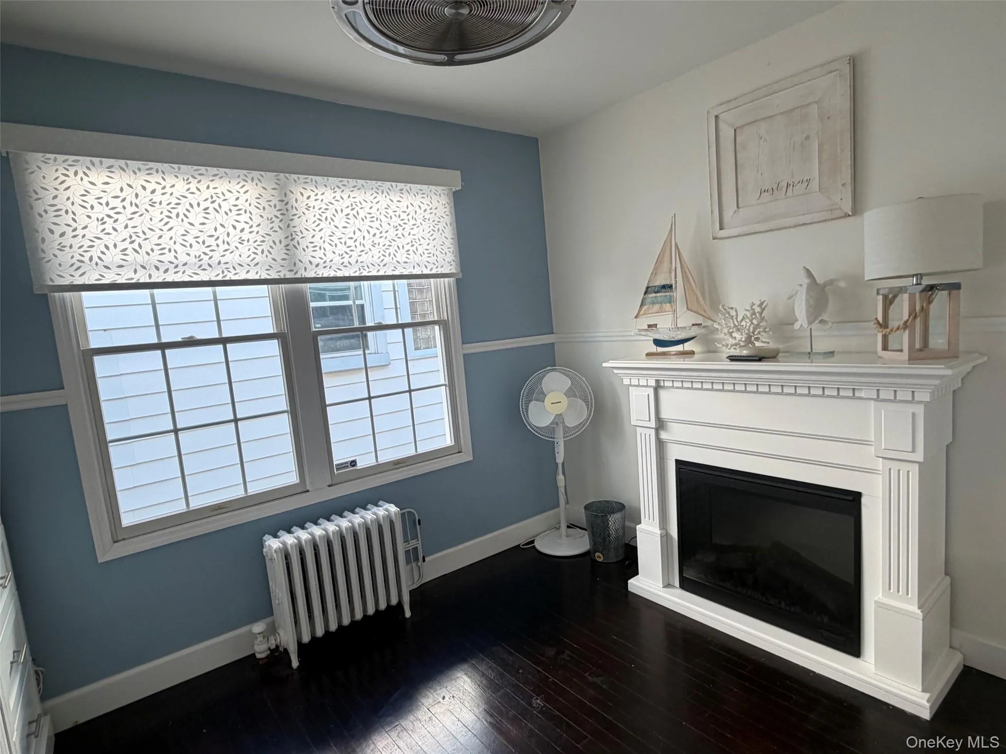 Dark wood-finish flooring complements the light blue and white wall tones Dark wood-finish flooring complements the light blue and white wall tones