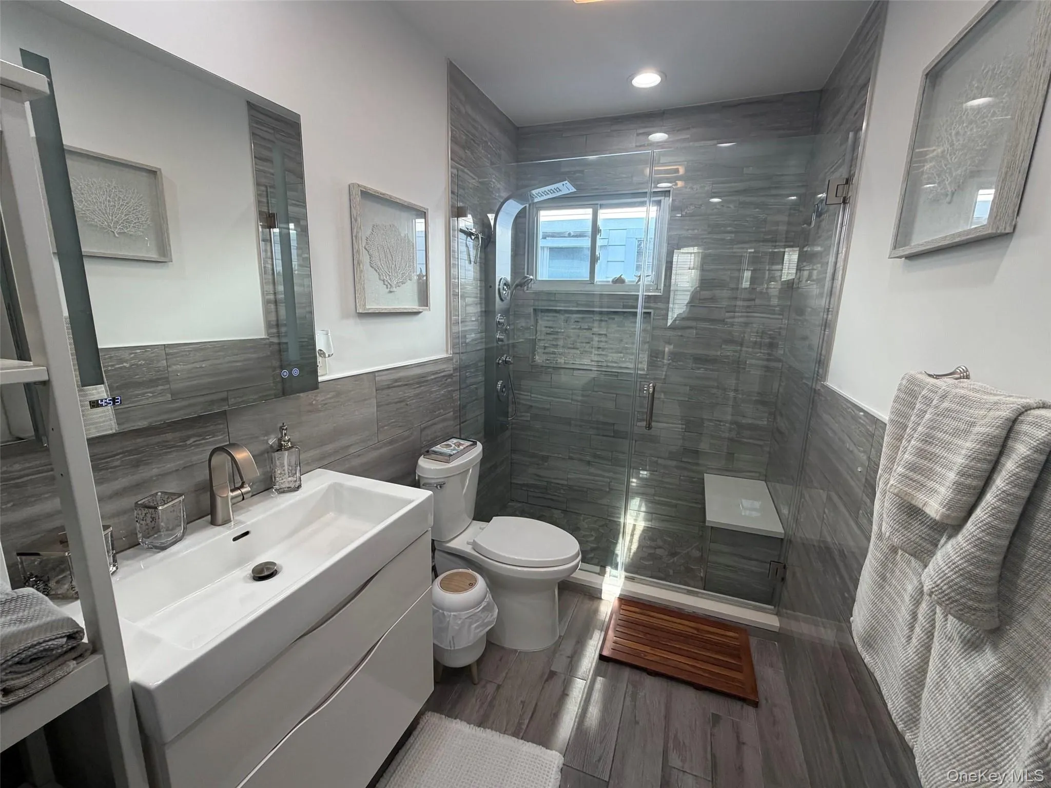 Bathroom featuring a floating vanity with an integrated sink. Bathroom featuring a floating vanity with an integrated sink.