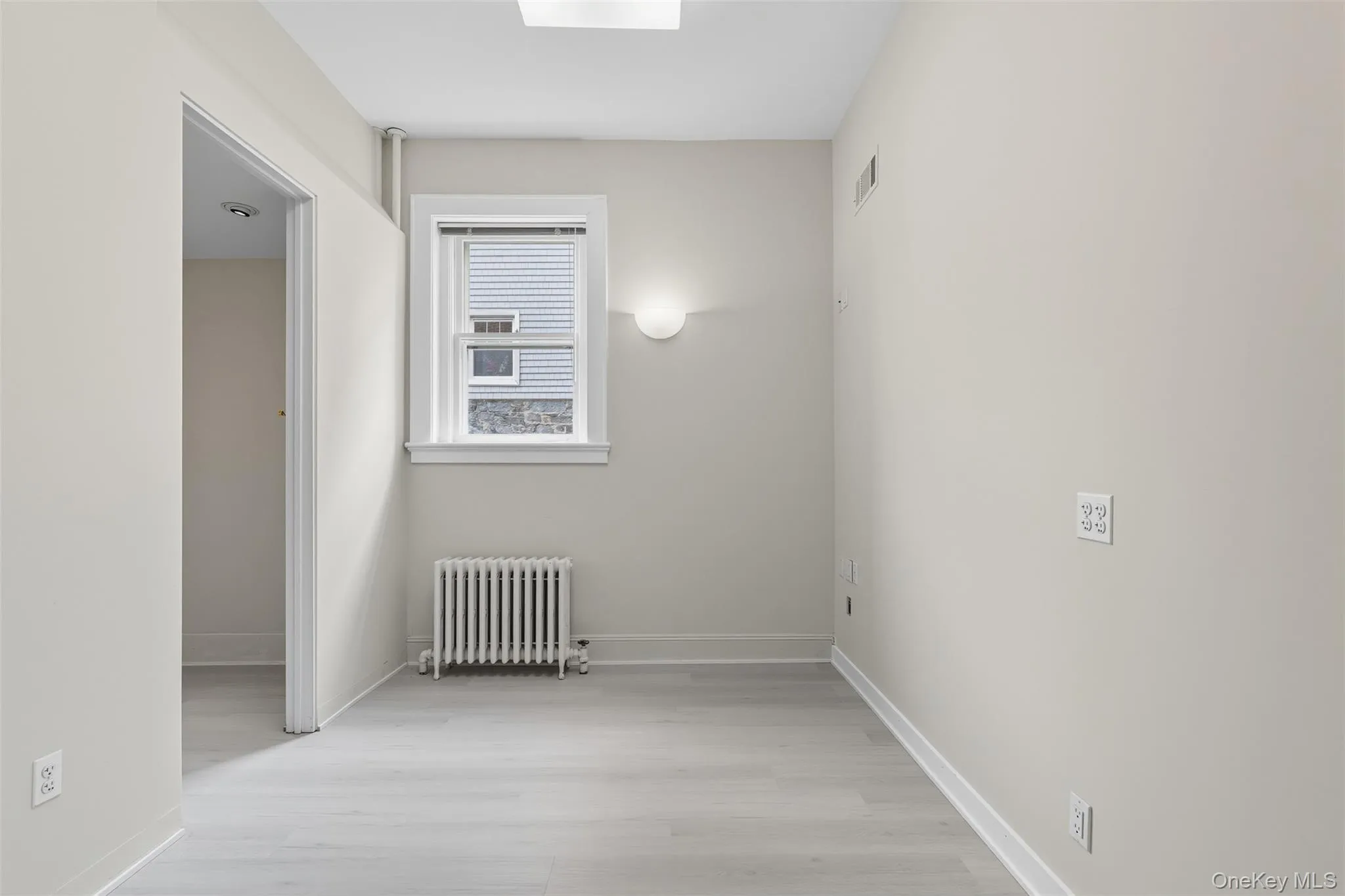 Light-toned wood-finish flooring complements neutral wall tones Light-toned wood-finish flooring complements neutral wall tones