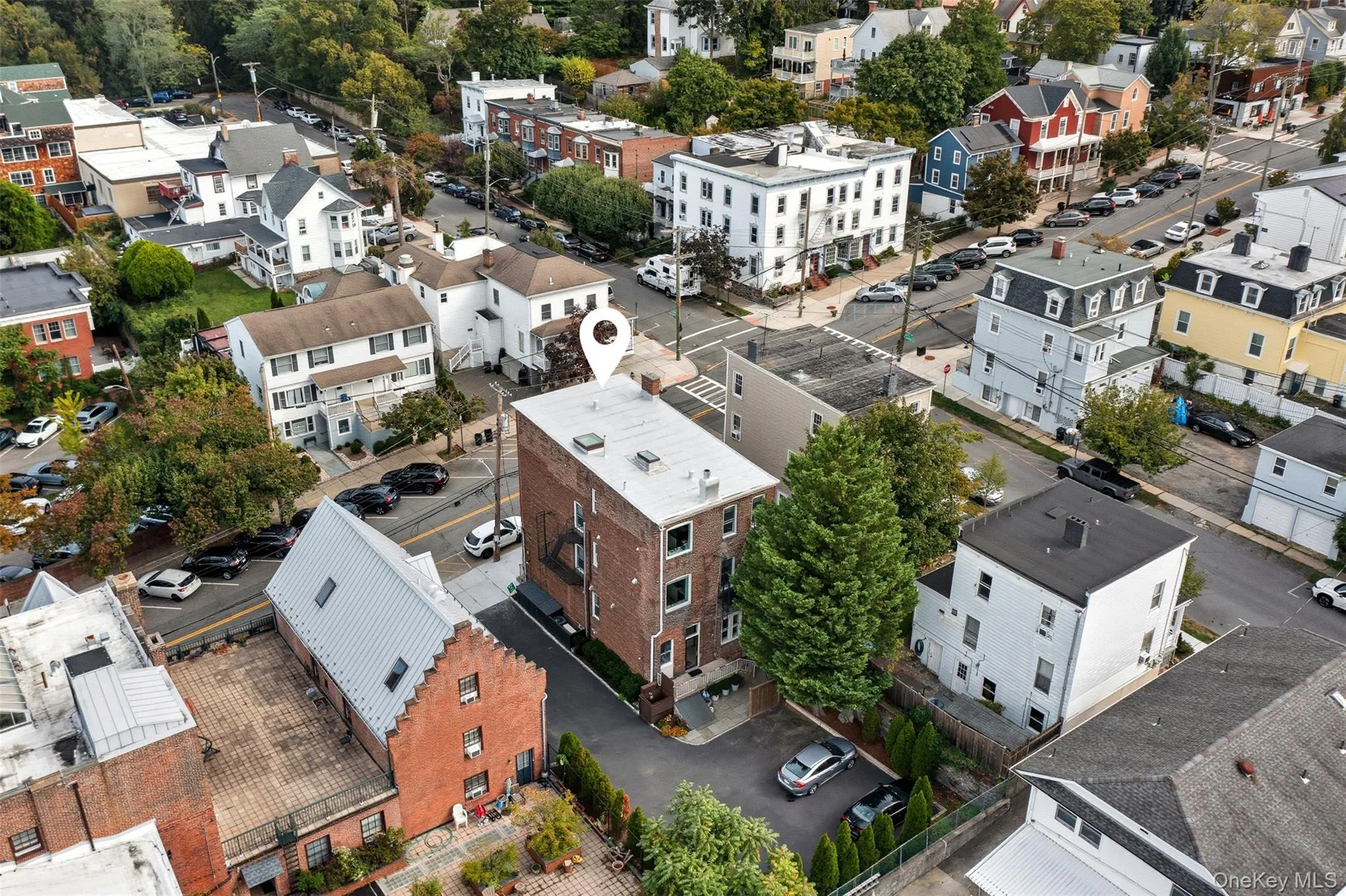 Brick facade building featuring multiple stories and a flat roofline Brick facade building featuring multiple stories and a flat roofline