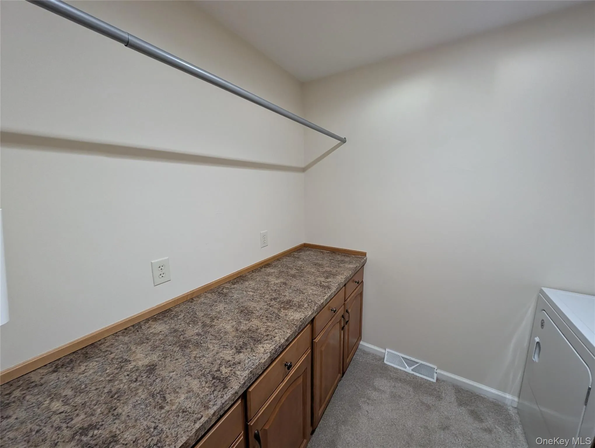 Laundry area featuring light carpet and washer / dryer Laundry area featuring light carpet and washer / dryer
