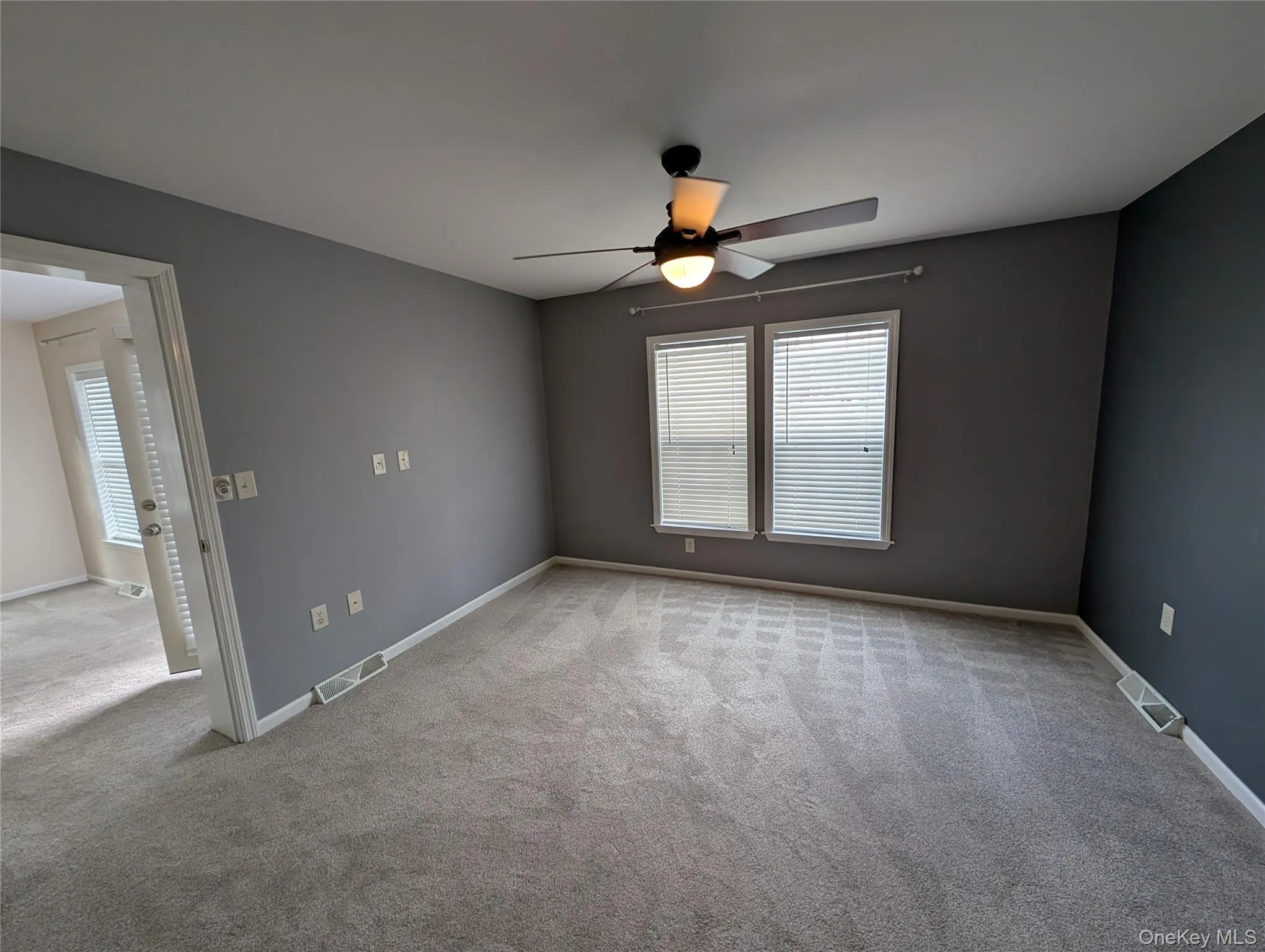Carpeted spare room featuring ceiling fan Carpeted spare room featuring ceiling fan