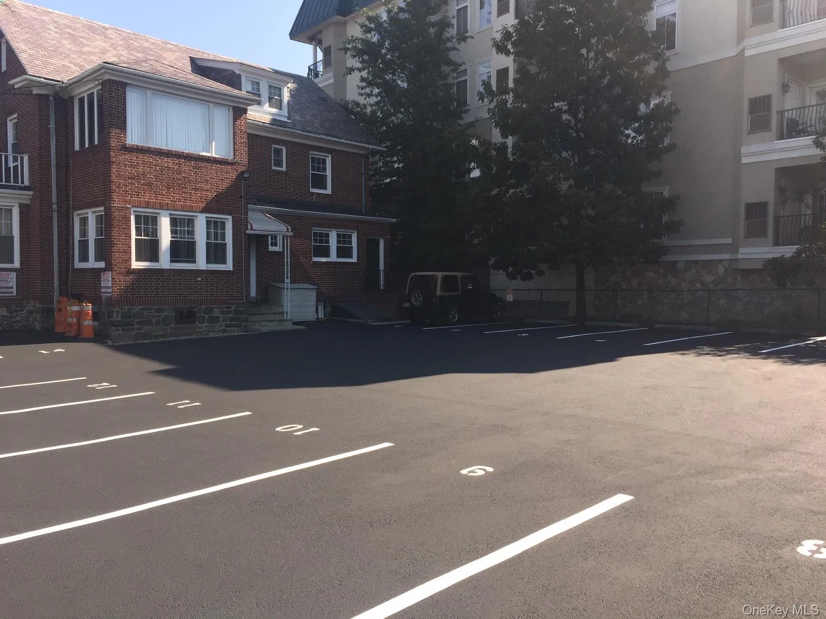 Paved parking lot with 14 marked spaces Paved parking lot with 14 marked spaces