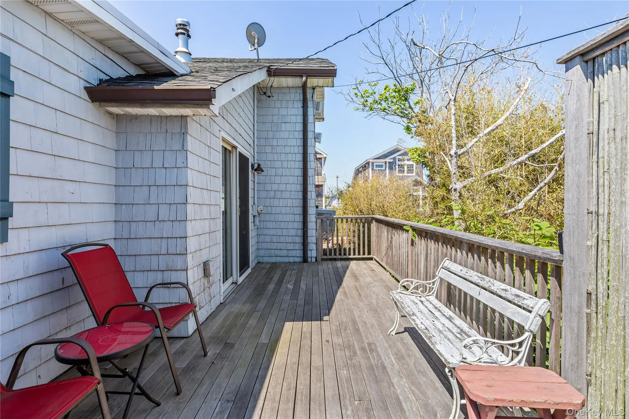 Expansive outdoor deck featuring wood flooring and a perimeter railing Expansive outdoor deck featuring wood flooring and a perimeter railing