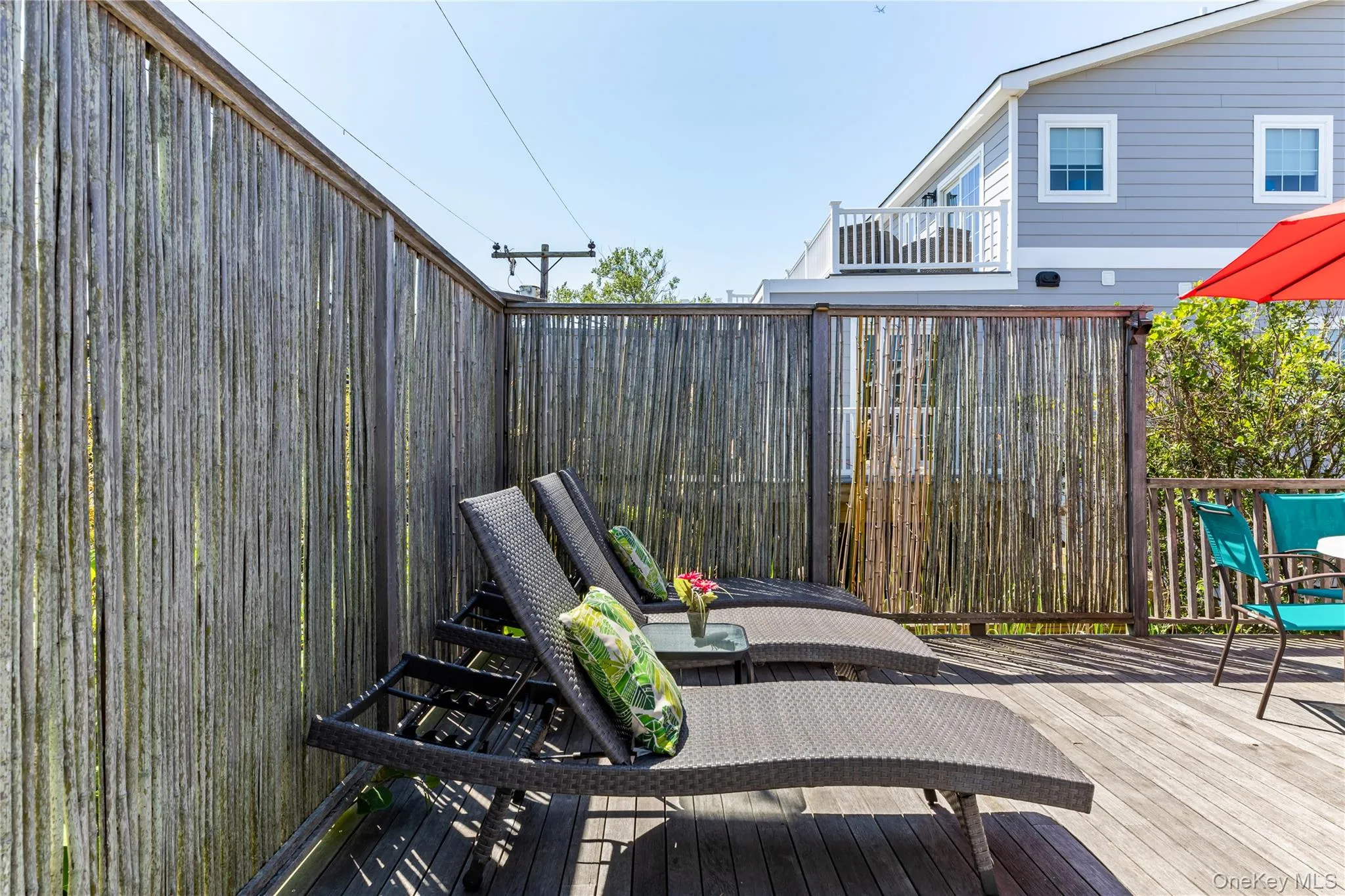 Outdoor wood deck featuring a bamboo privacy screen Outdoor wood deck featuring a bamboo privacy screen