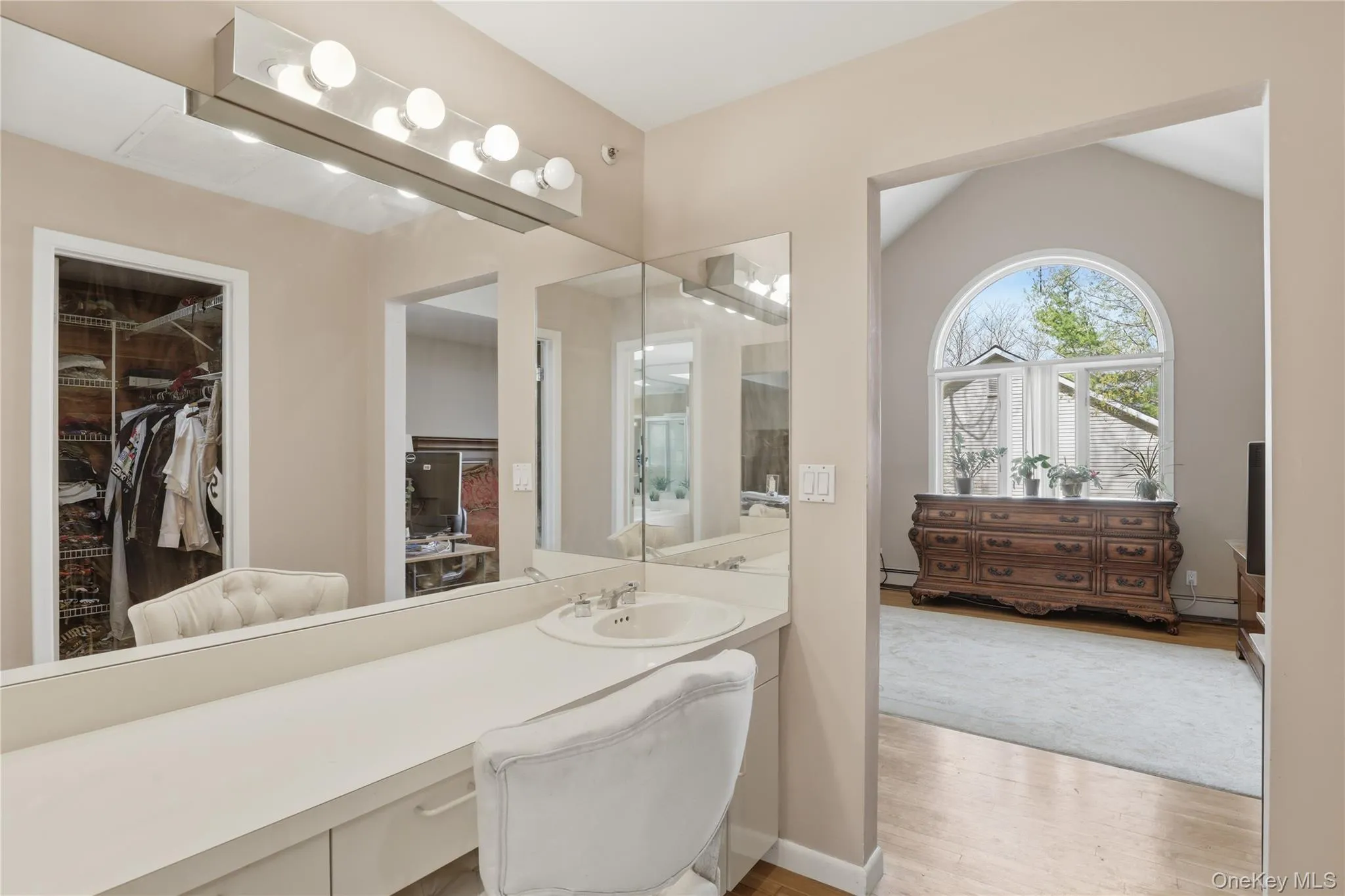Integrated vanity with an undermount sink and expansive mirror Integrated vanity with an undermount sink and expansive mirror