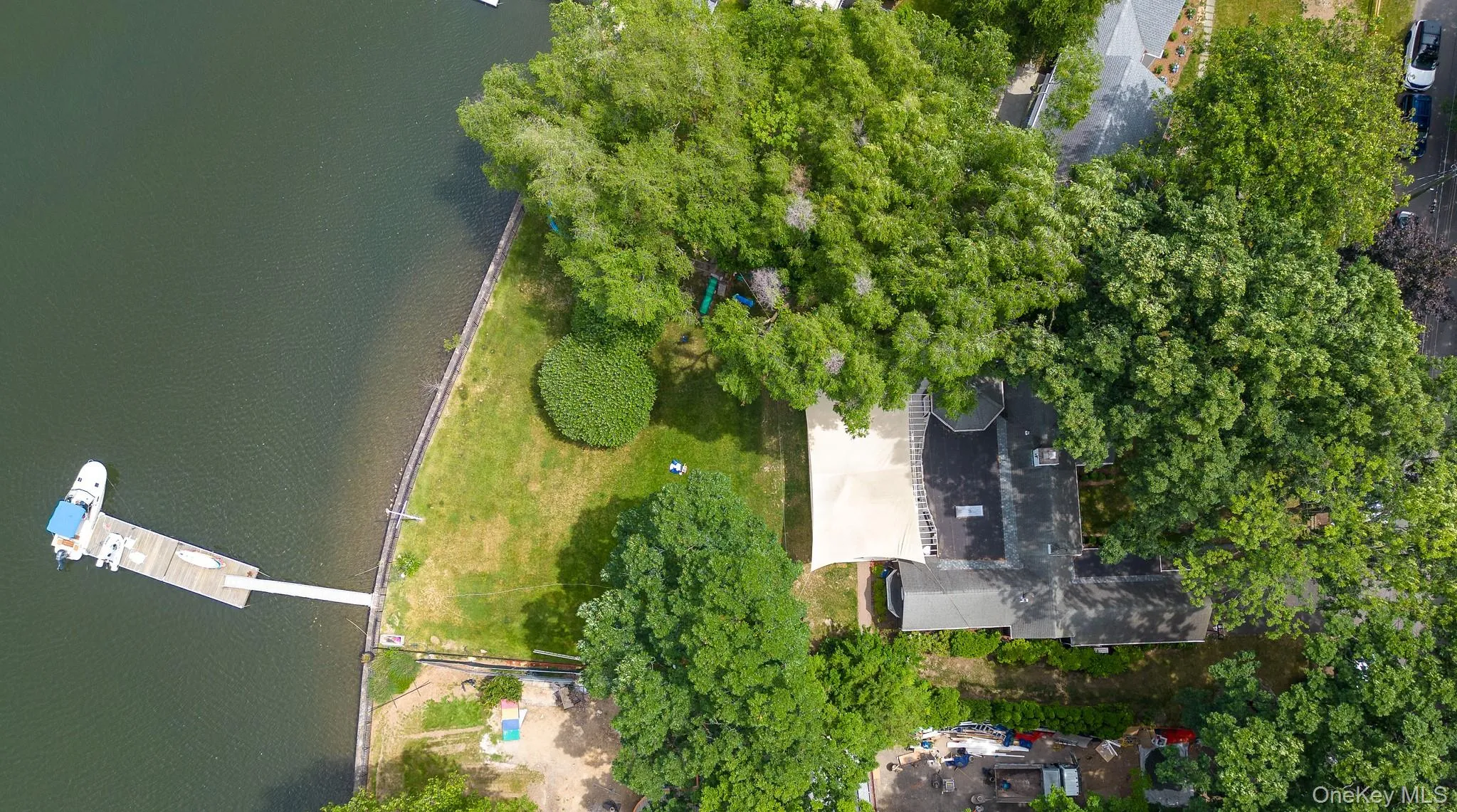 Aerial View of waterfront property featuring a private dock with boat slip. Aerial View of waterfront property featuring a private dock with boat slip.