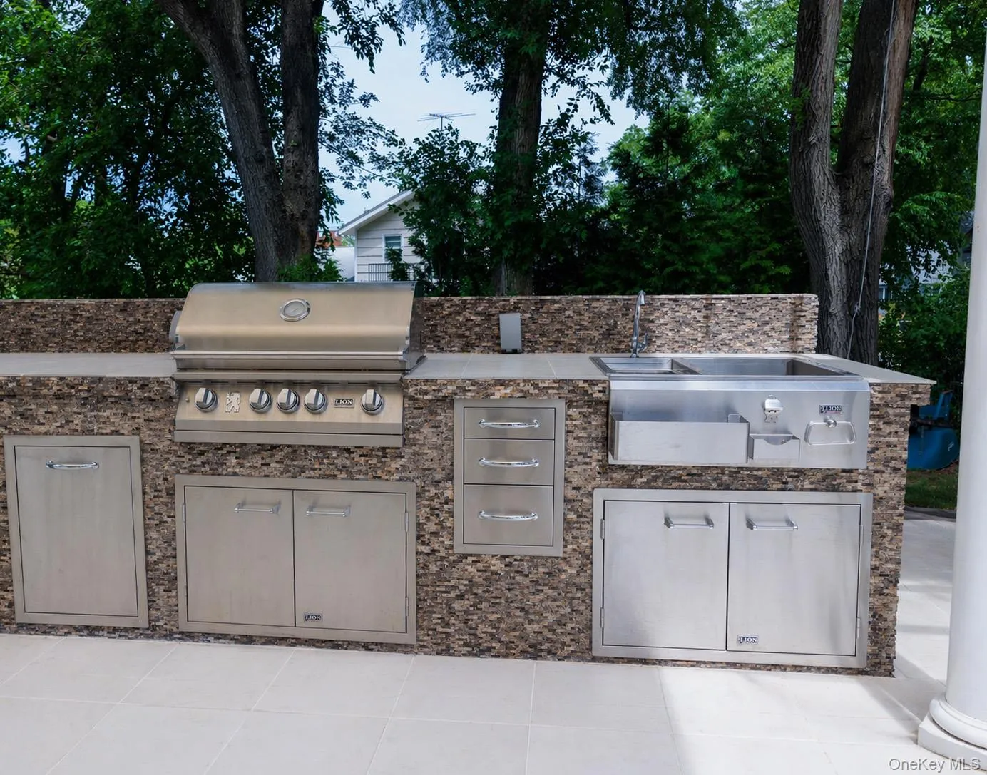 Outdoor kitchen featuring a built-in grill and sink! Outdoor kitchen featuring a built-in grill and sink!