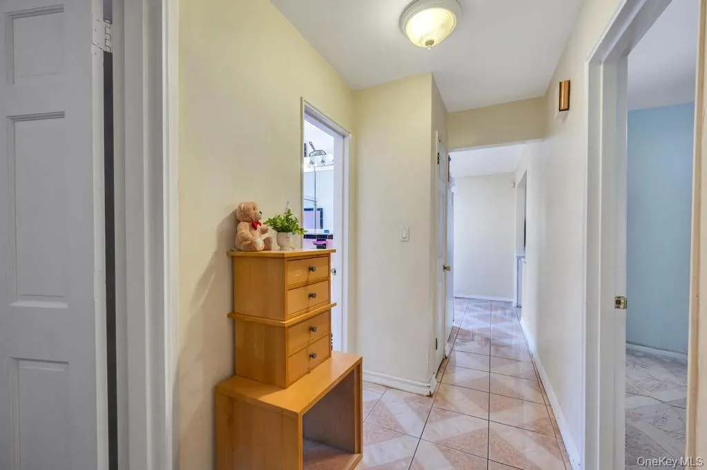 Hallway with neutral wall tones and patterned floor tiles Hallway with neutral wall tones and patterned floor tiles