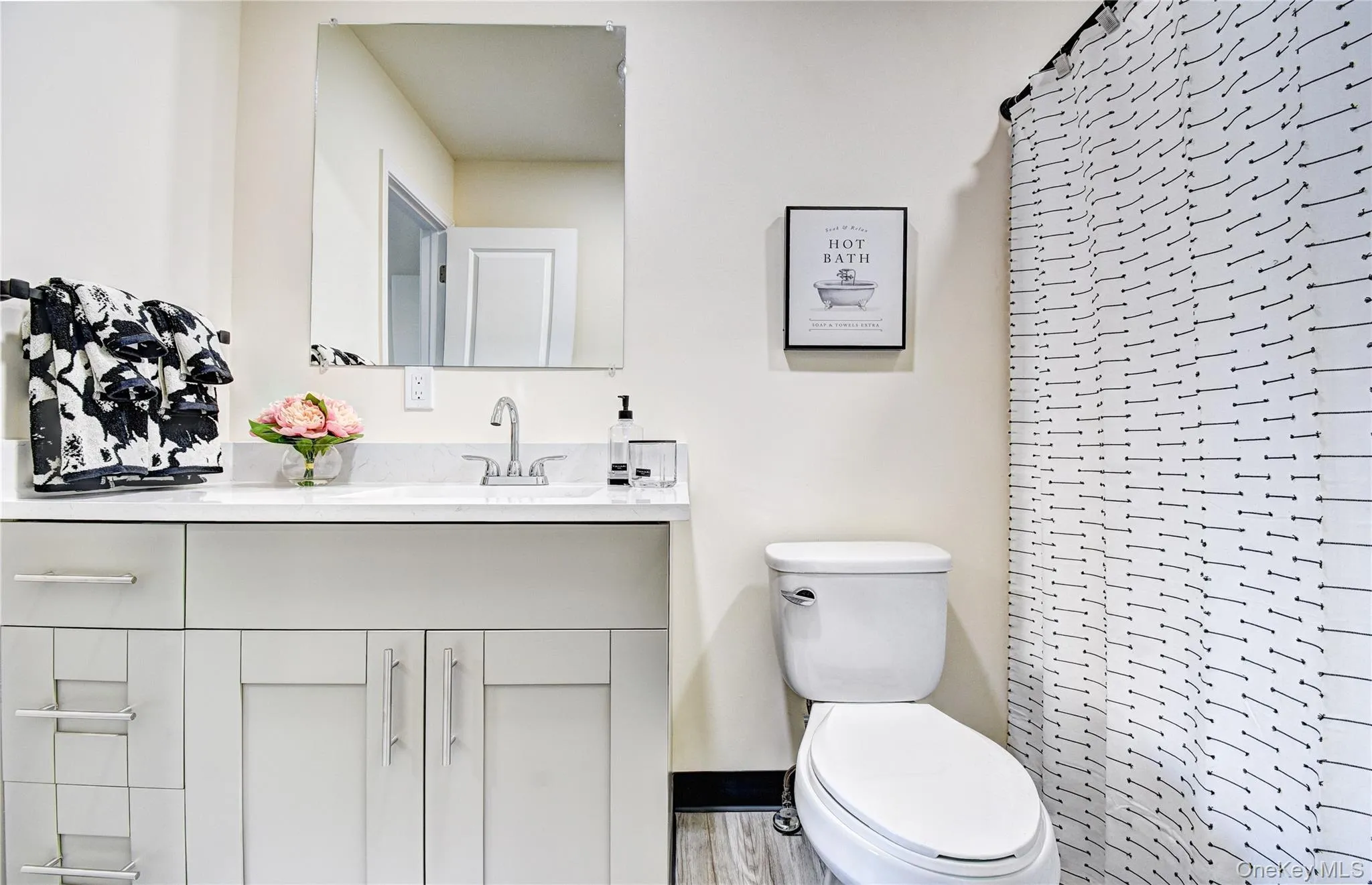Bathroom featuring toilet, a shower, and vanity Bathroom featuring toilet, a shower, and vanity