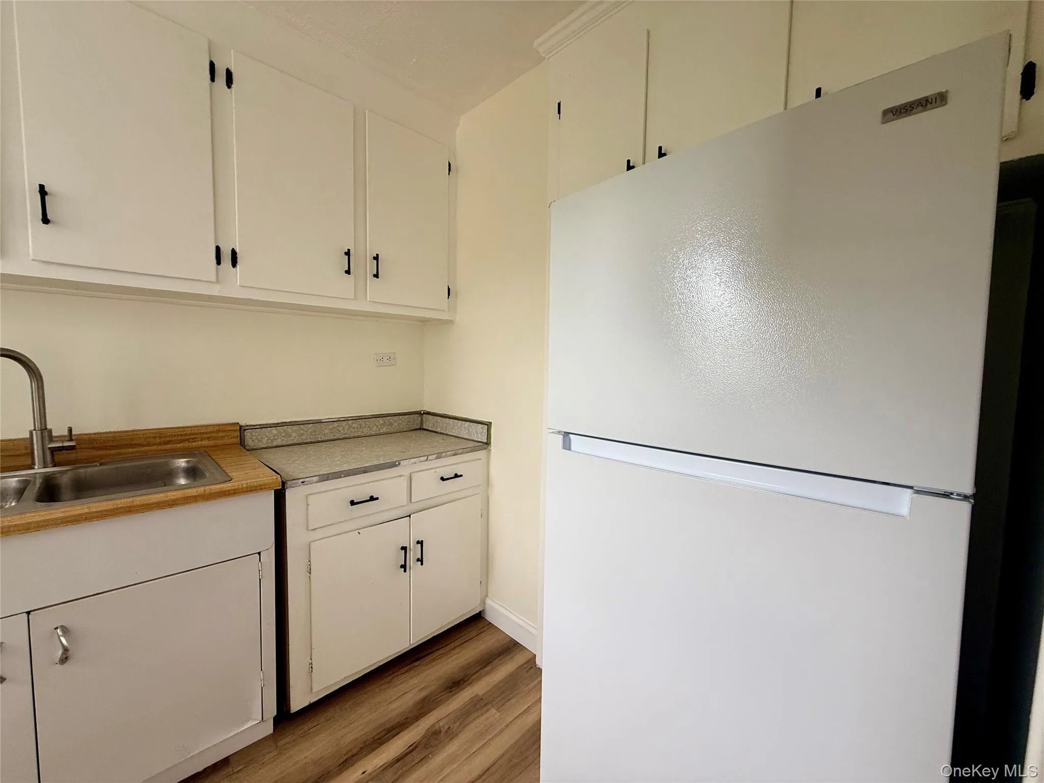 Kitchen with original wood cabinets, stainless steel sink, plenty of cabinets, large window for ventilation. Kitchen with original wood cabinets, stainless steel sink, plenty of cabinets, large window for ventilation.