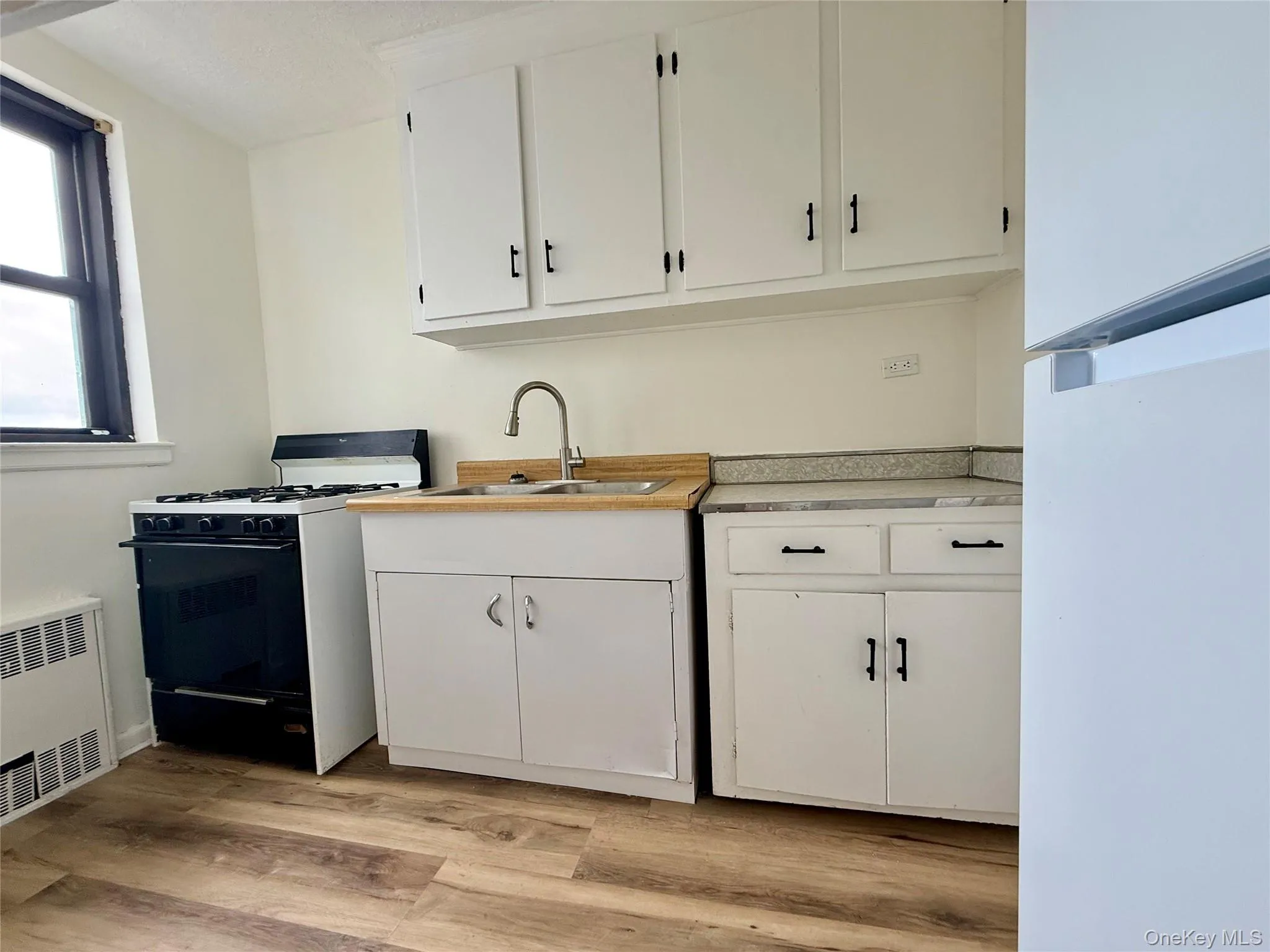 Kitchen with original wood cabinets, stainless steel sink, plenty of cabinets, large window for ventilation. Kitchen with original wood cabinets, stainless steel sink, plenty of cabinets, large window for ventilation.