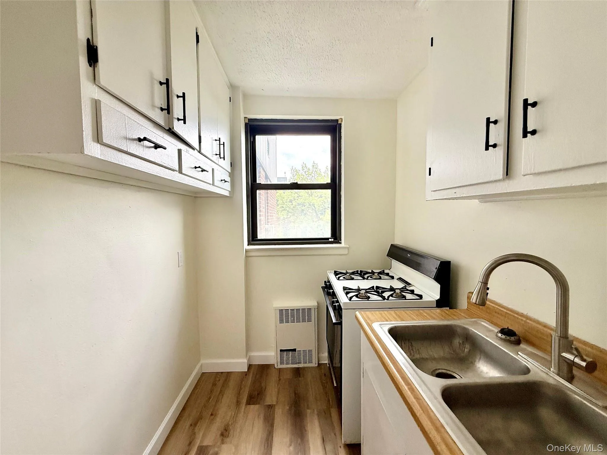 Kitchen with original wood cabinets, stainless steel sink, plenty of cabinets, large window for ventilation. Kitchen with original wood cabinets, stainless steel sink, plenty of cabinets, large window for ventilation.
